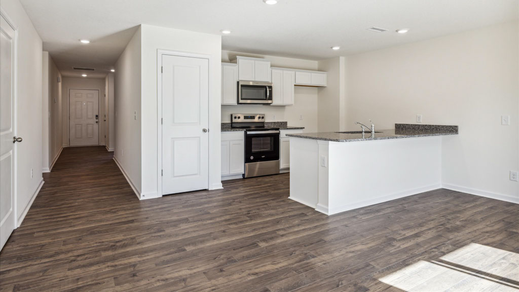 A foyer and entry hall combination features a welcoming front with a direct line of sight through the main living areas