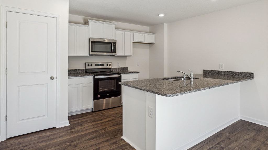 Kitchen with stainless steel appliances, shaker style cabinets, and elevated finishes