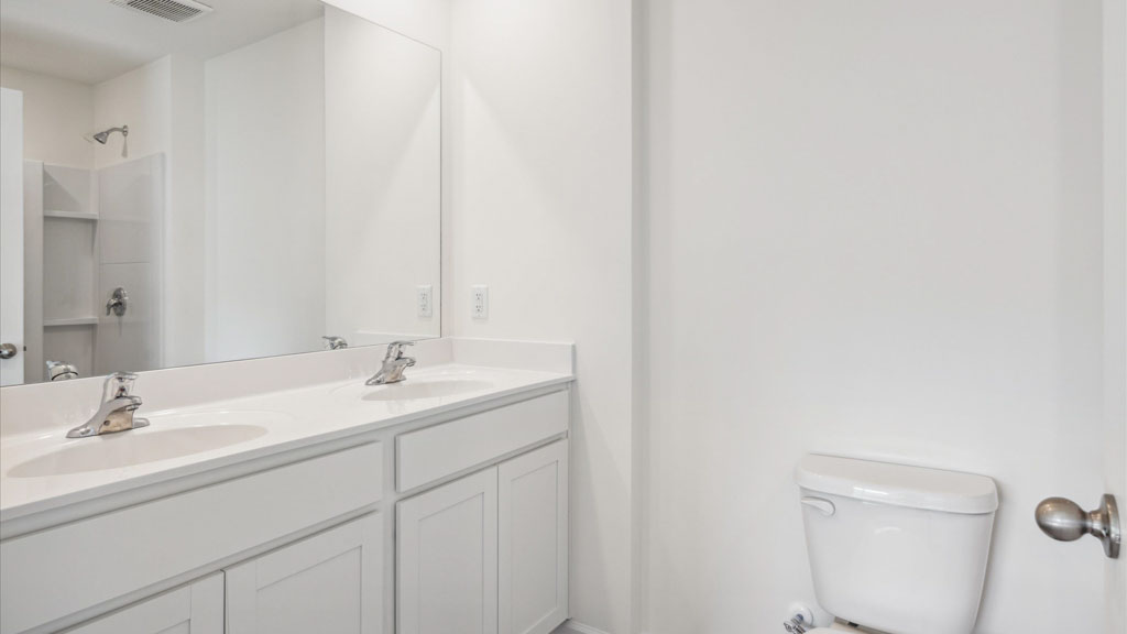 Private attached primary bathroom with built in vanity