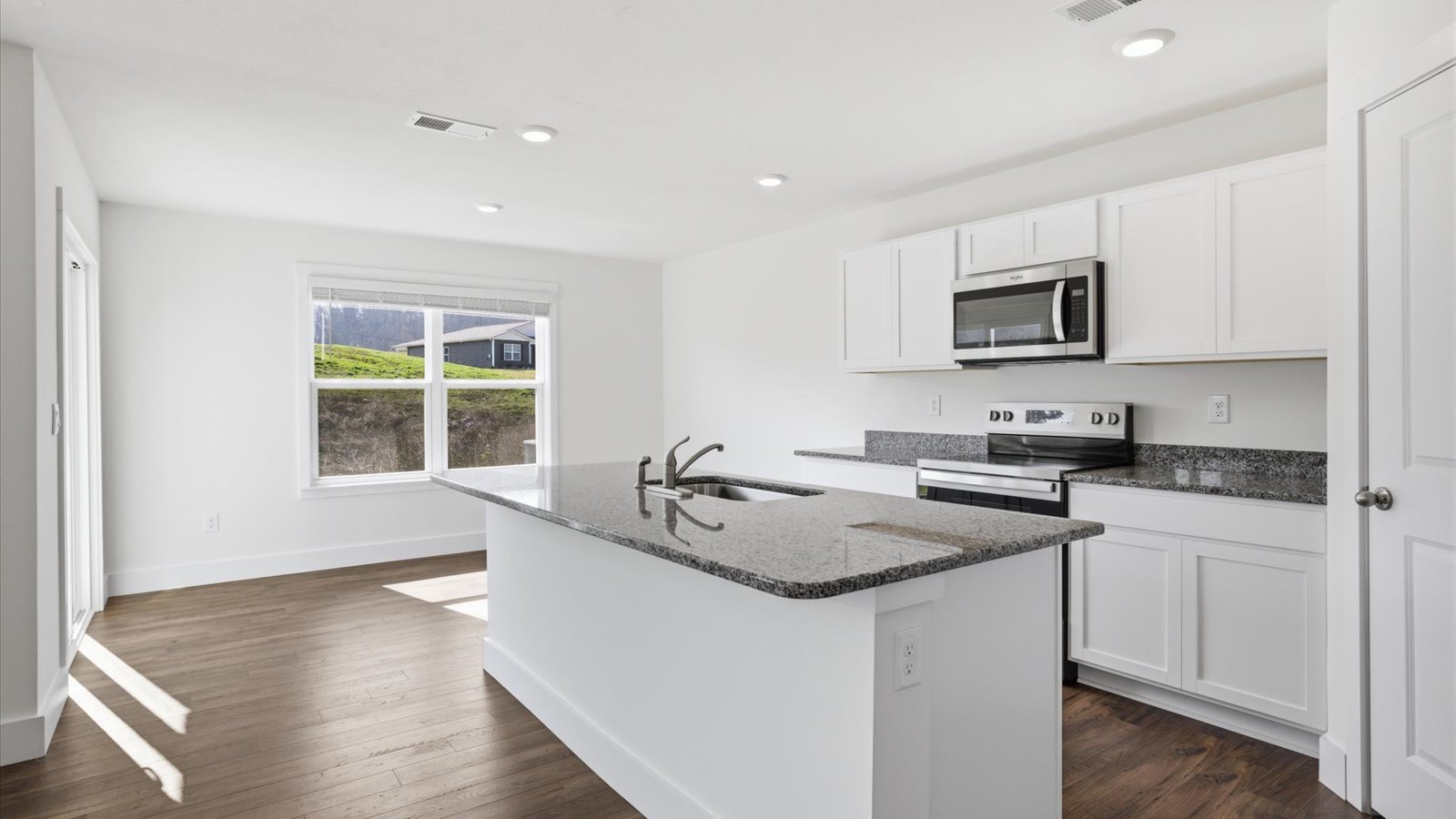 kitchen with granite island and stainless steel appliances and dining nook