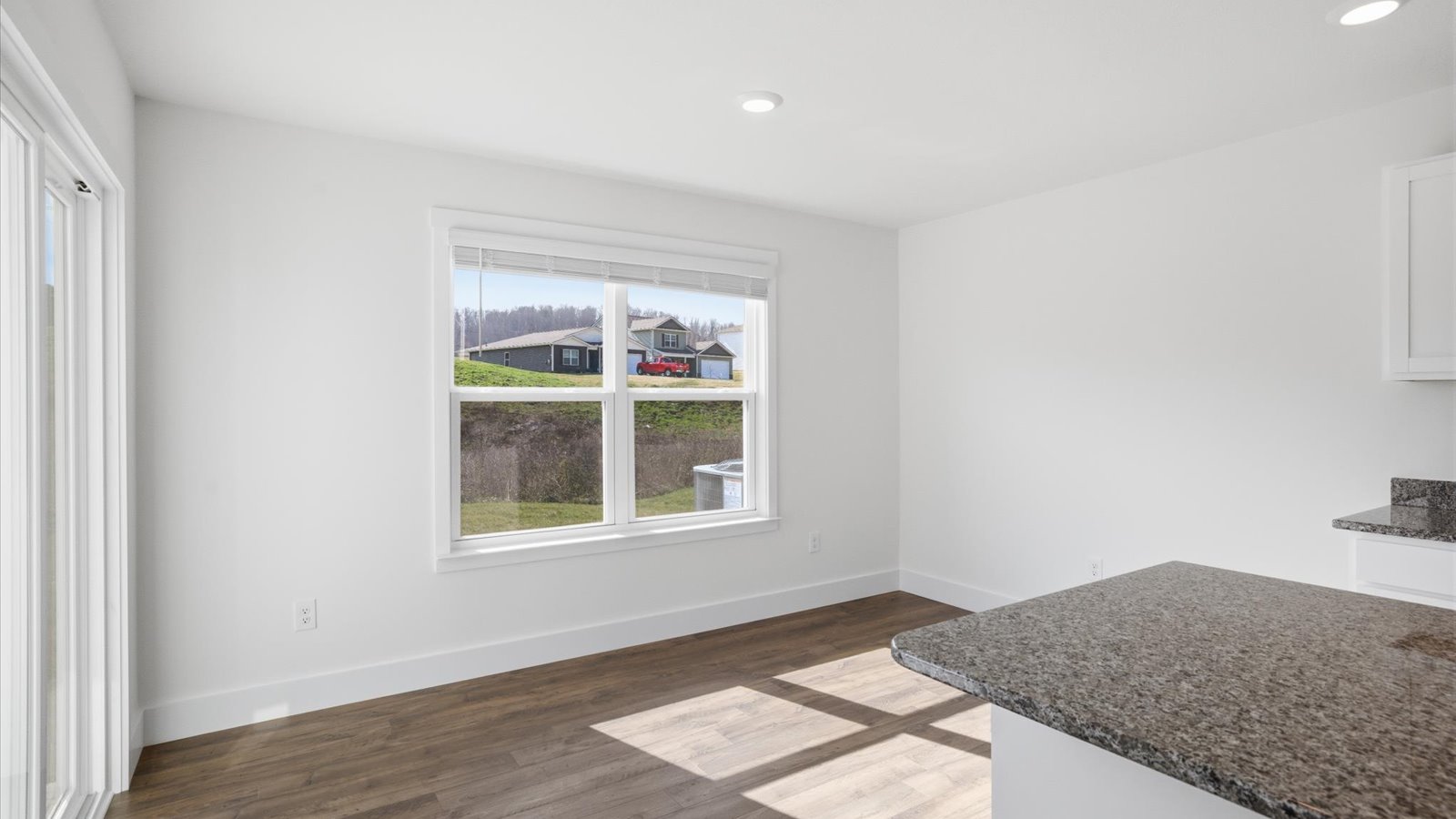 dining nook adjacent to kitchen with large window