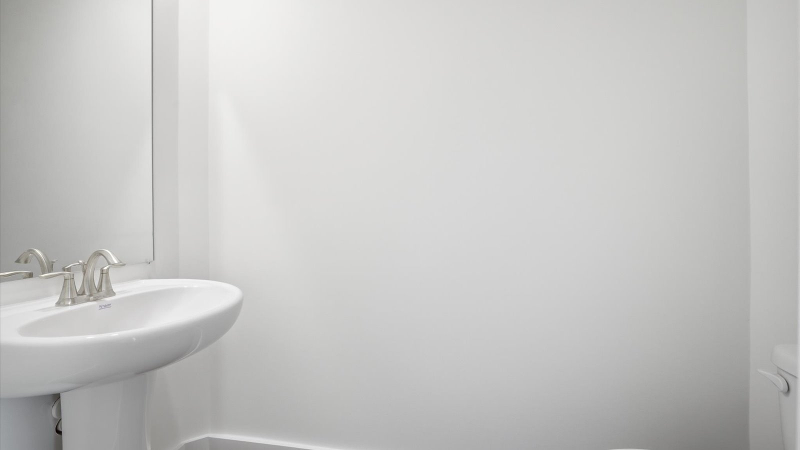 half bathroom with pedestal sink