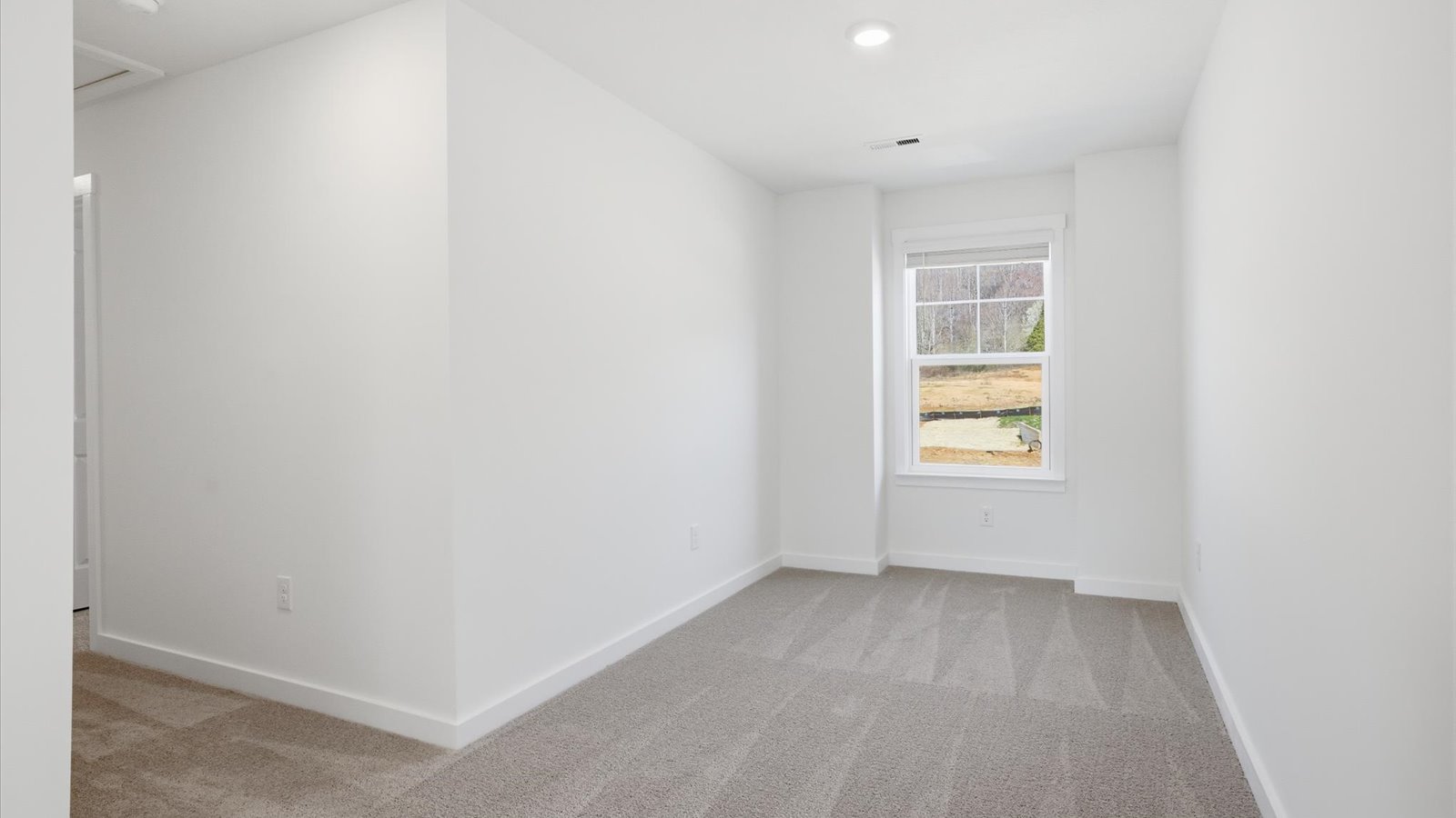 upstairs landing loft area with carpet and window