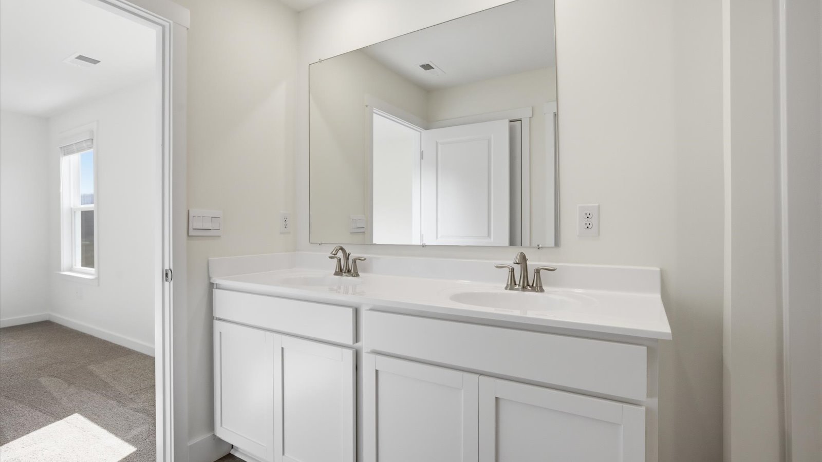double bowl vanity and large mirror with vanity lighting