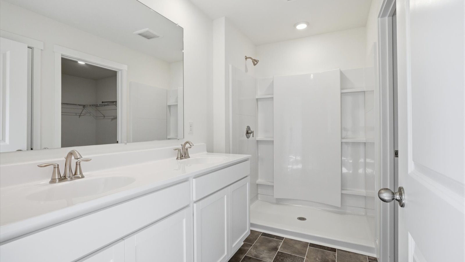 primary bathroom with double bowl vanity and walk in shower