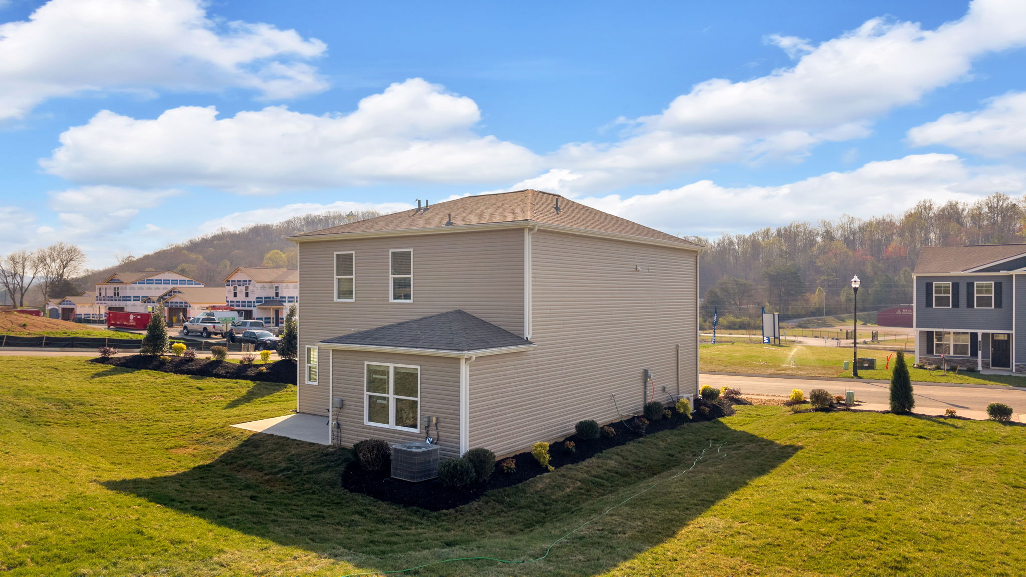 Exterior of two story modern brick home					 with back patio.