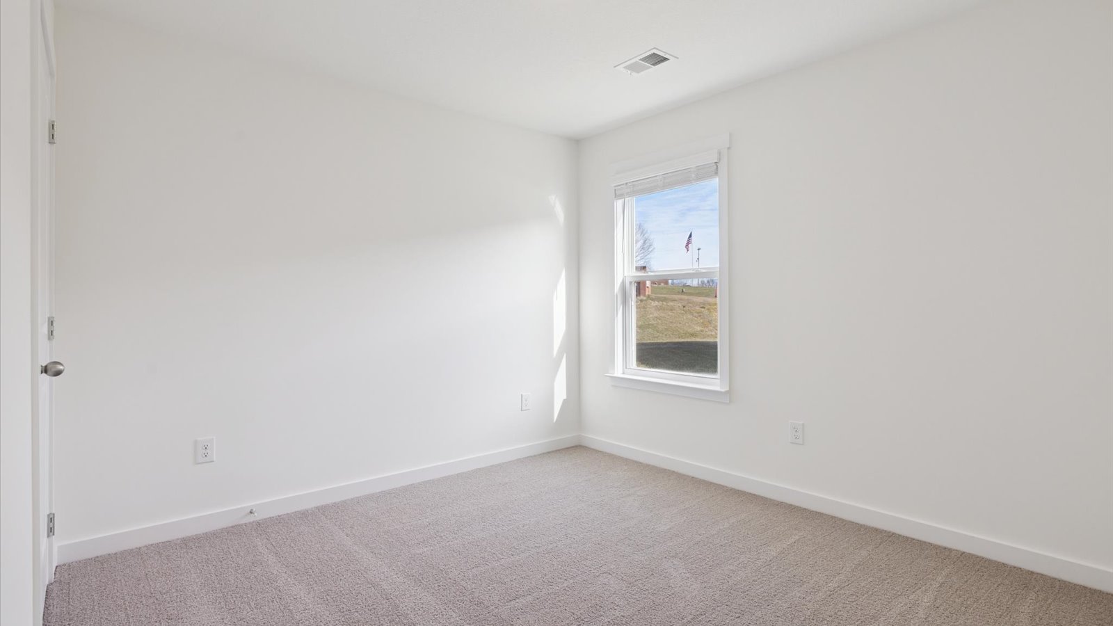 Bedroom with ample natural light and carpet floors
