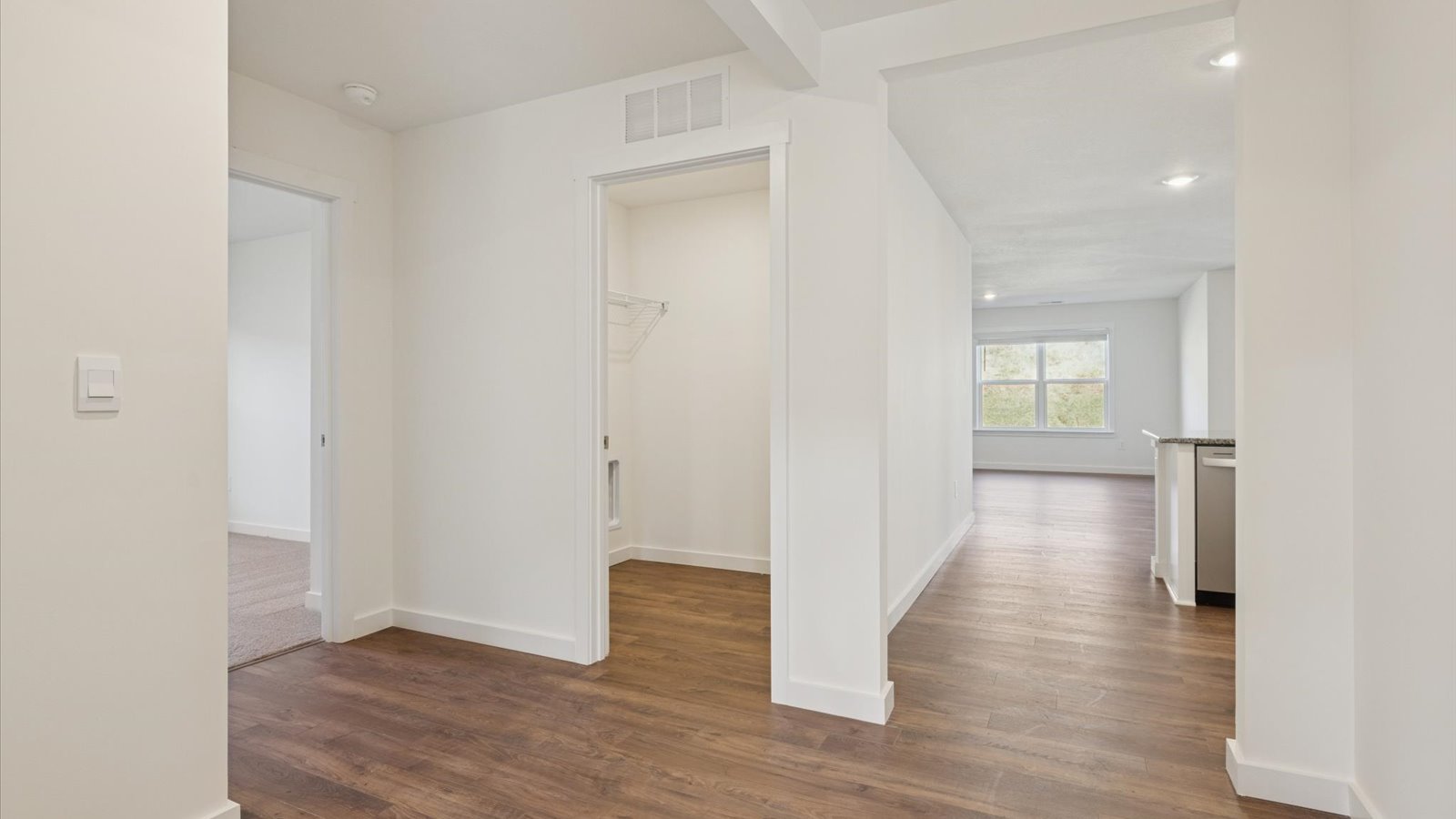Bright hallway with hardwood flooring
