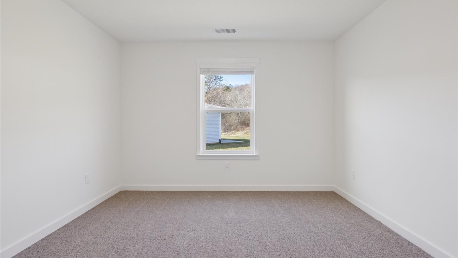 Bedroom with ample natural light and carpet floors