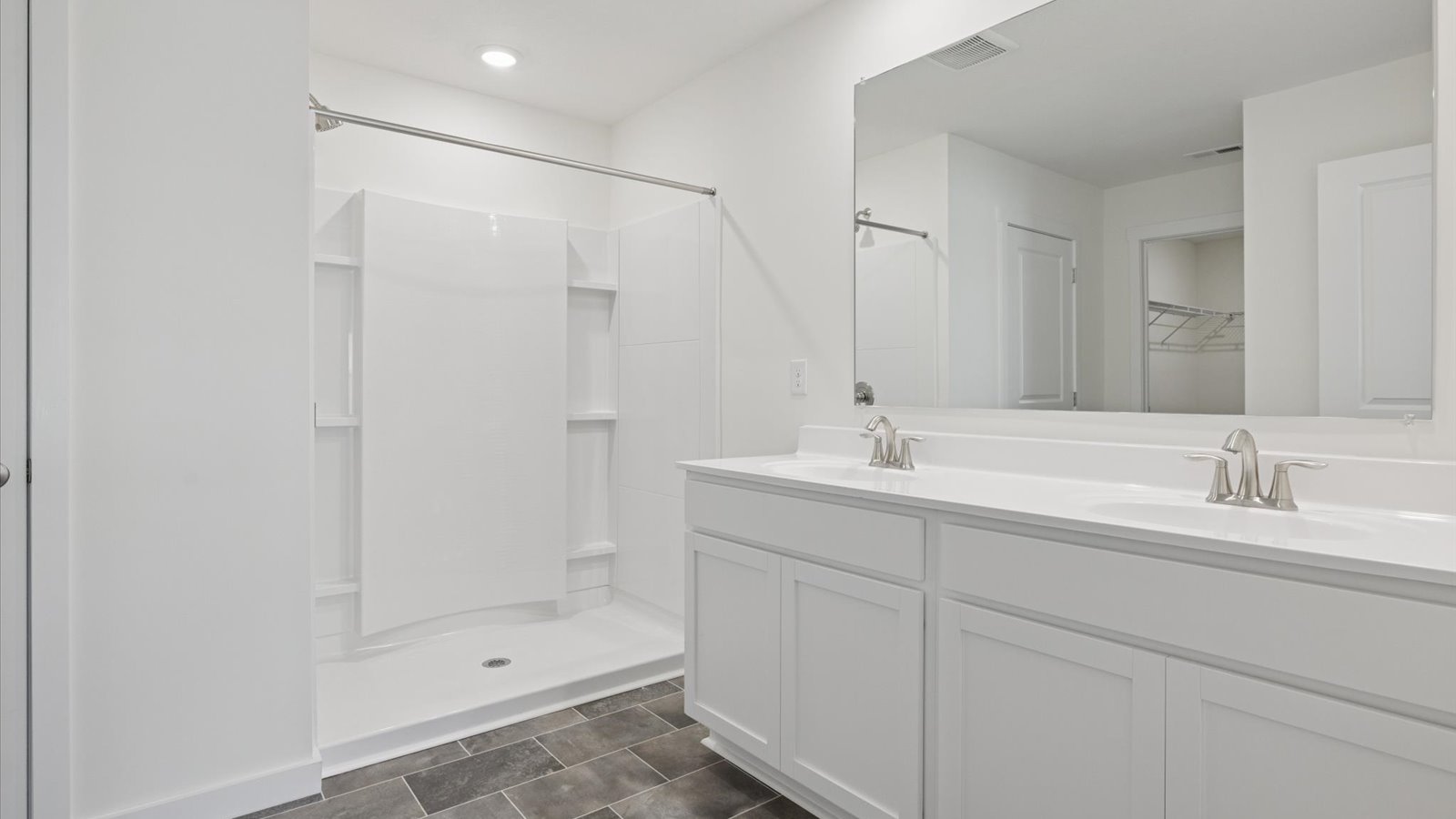 Primary bathroom with double vanity and walk-in shower