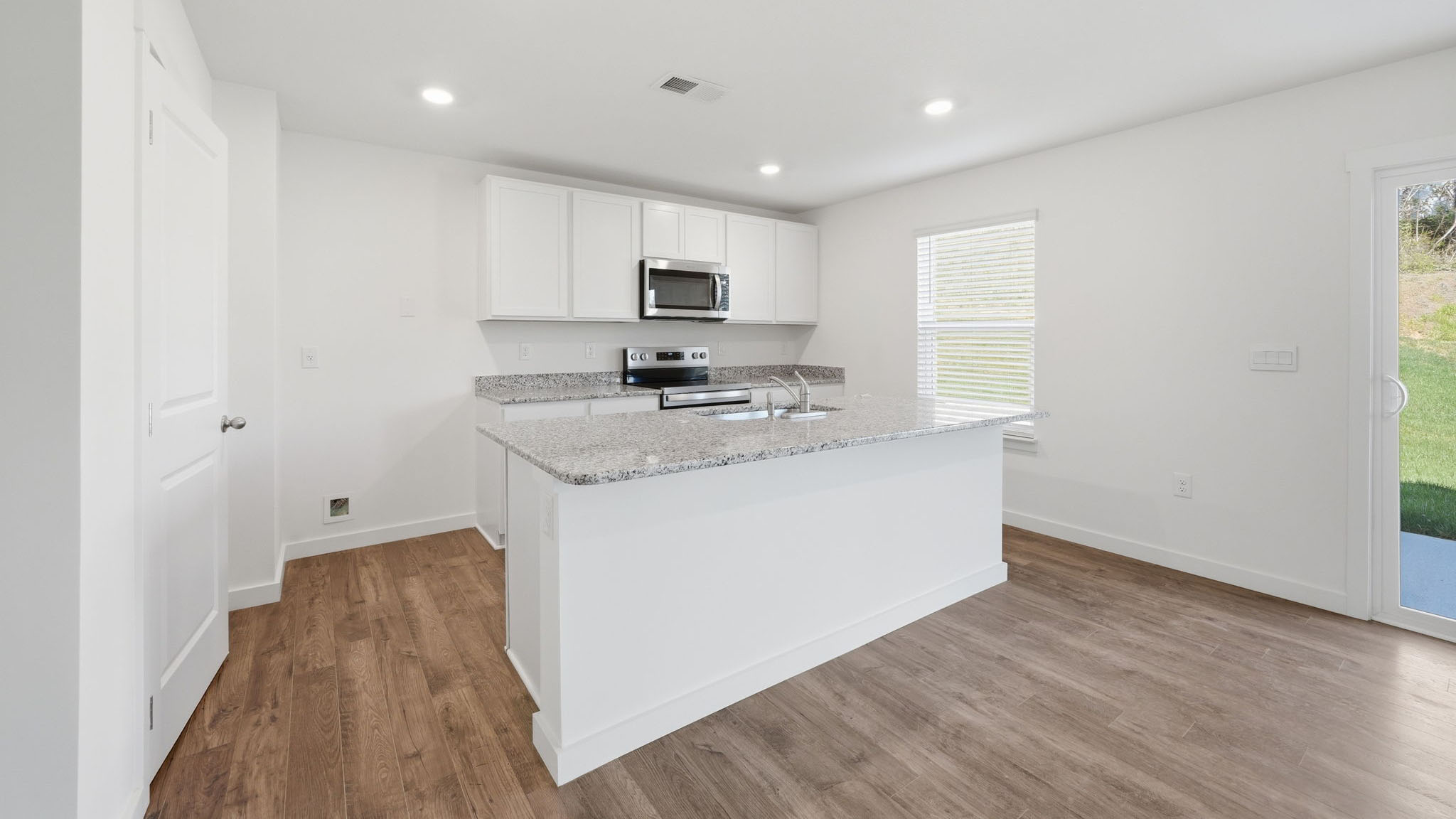 Open concept living, dining, and kitchen space