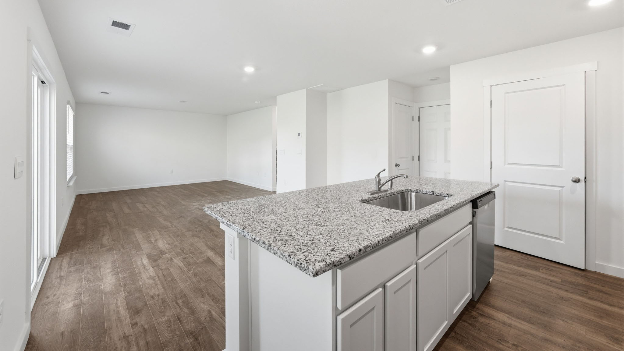 Open concept living, dining, and kitchen space