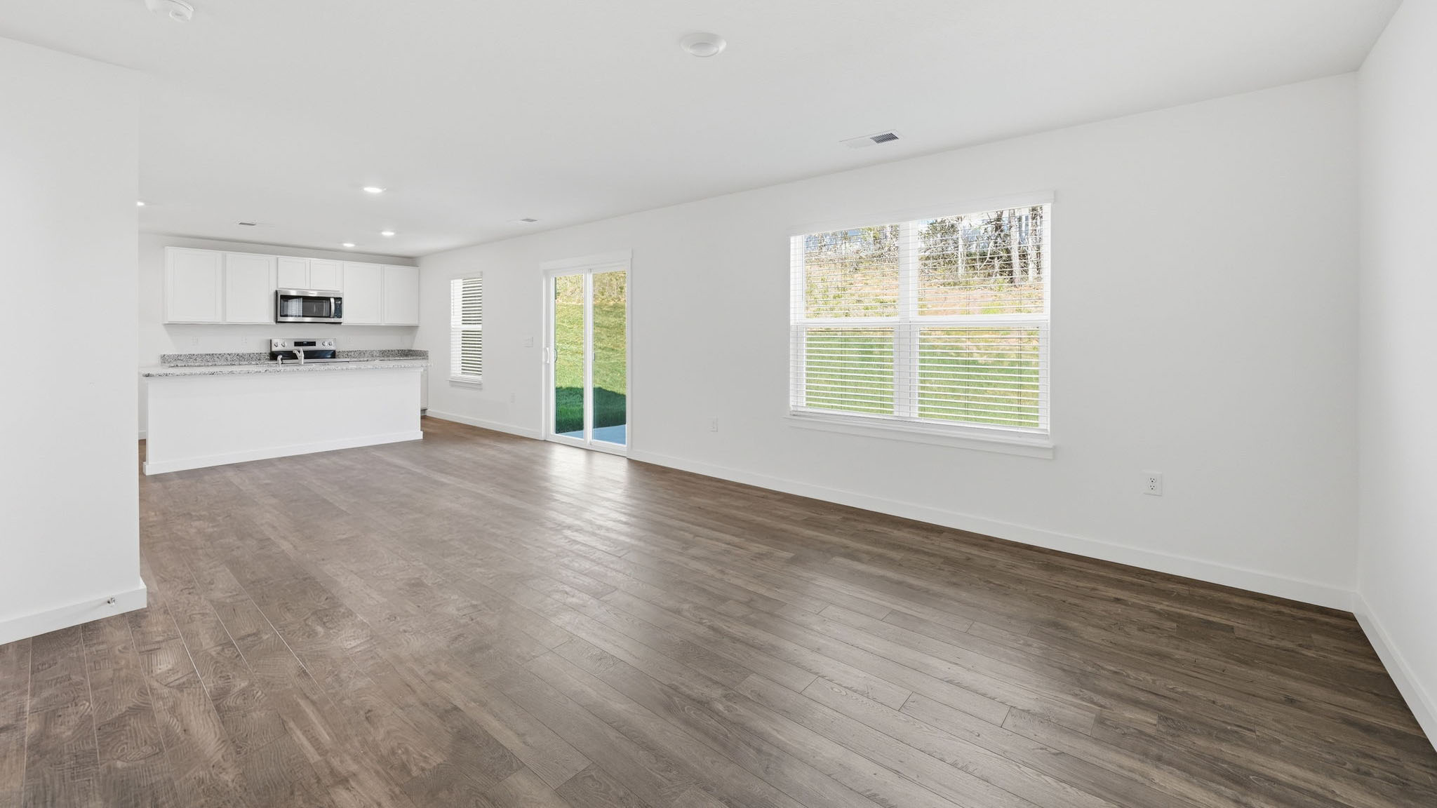 Open concept living, dining, and kitchen space