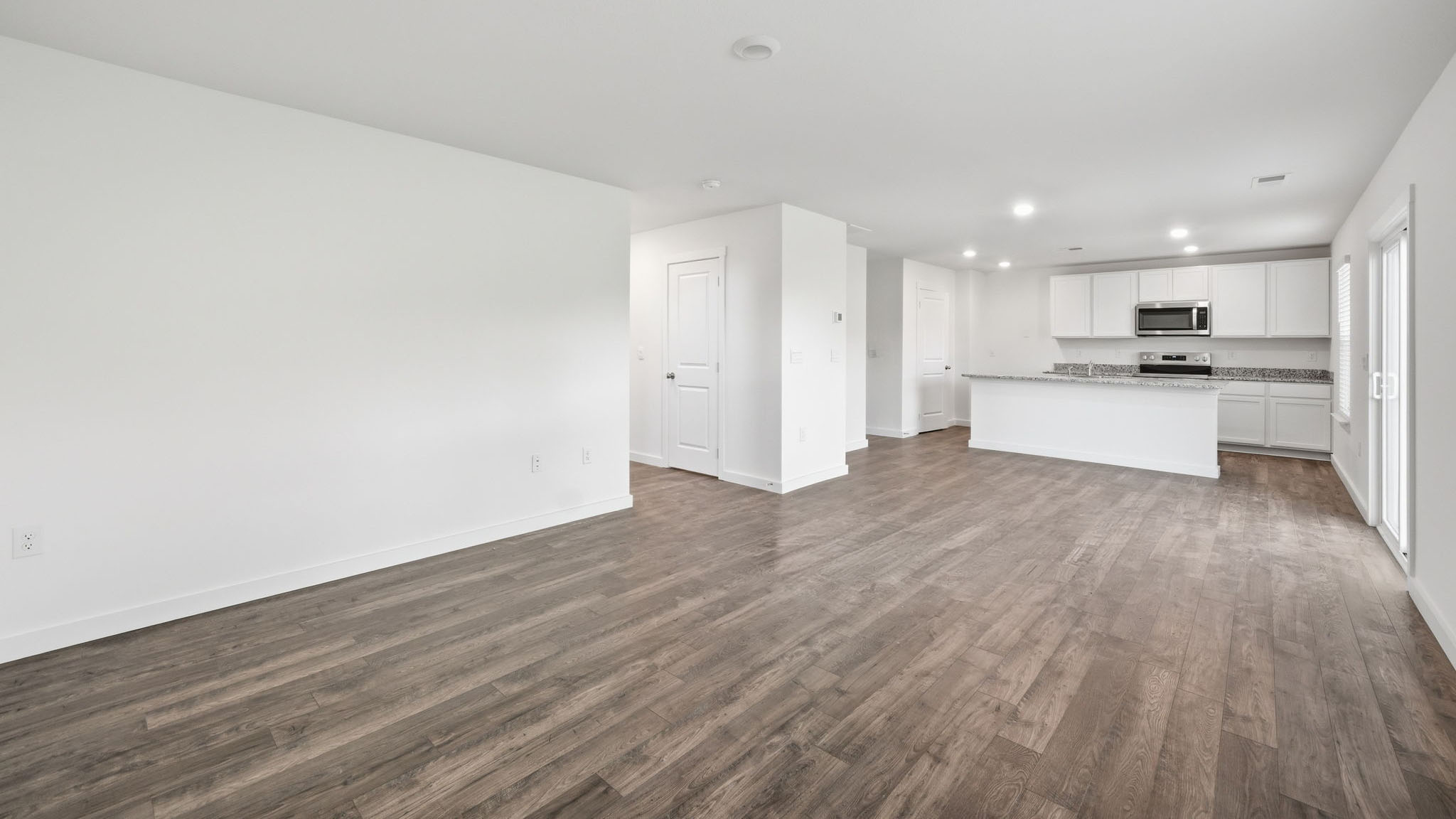 Open concept living, dining, and kitchen space