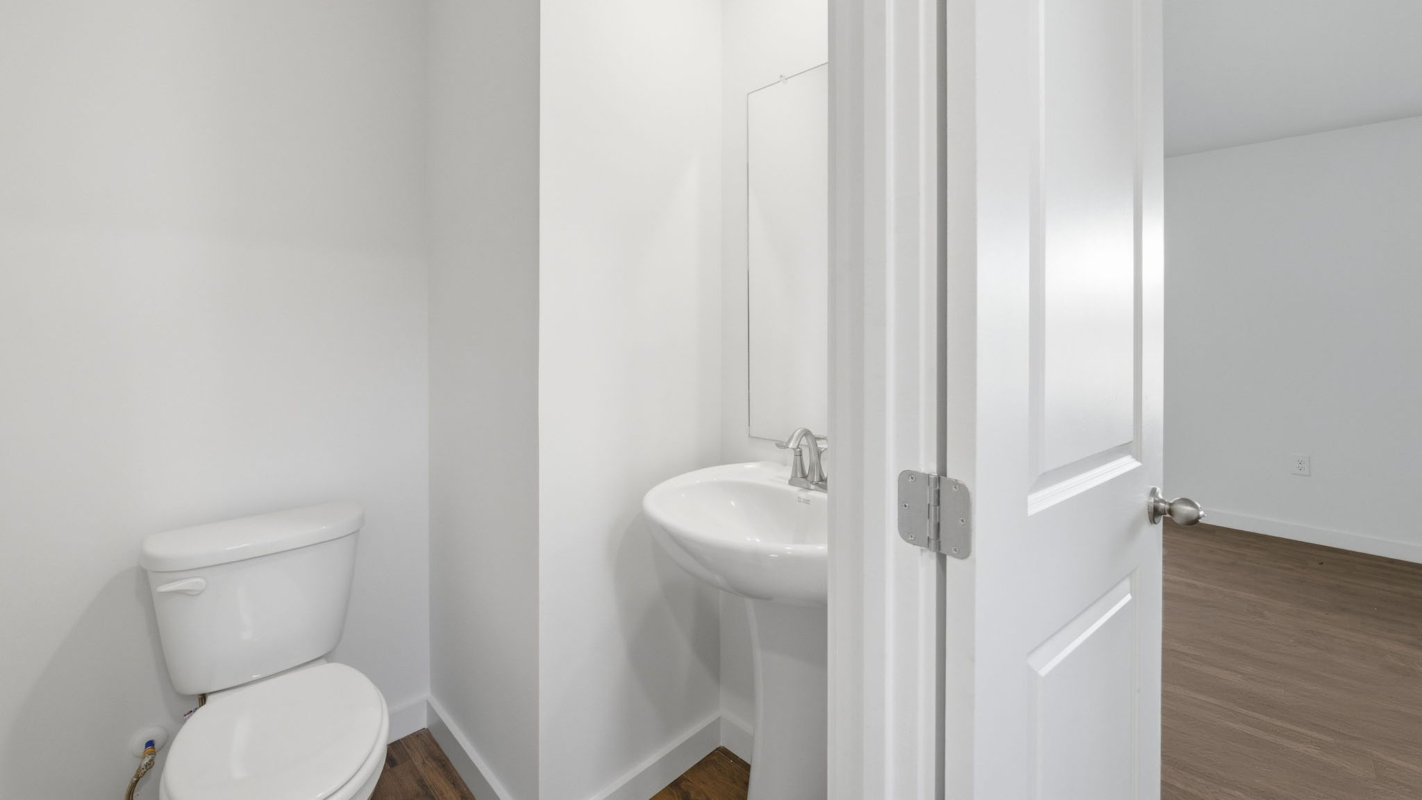 Downstairs guest half bathroom with pedestal sink