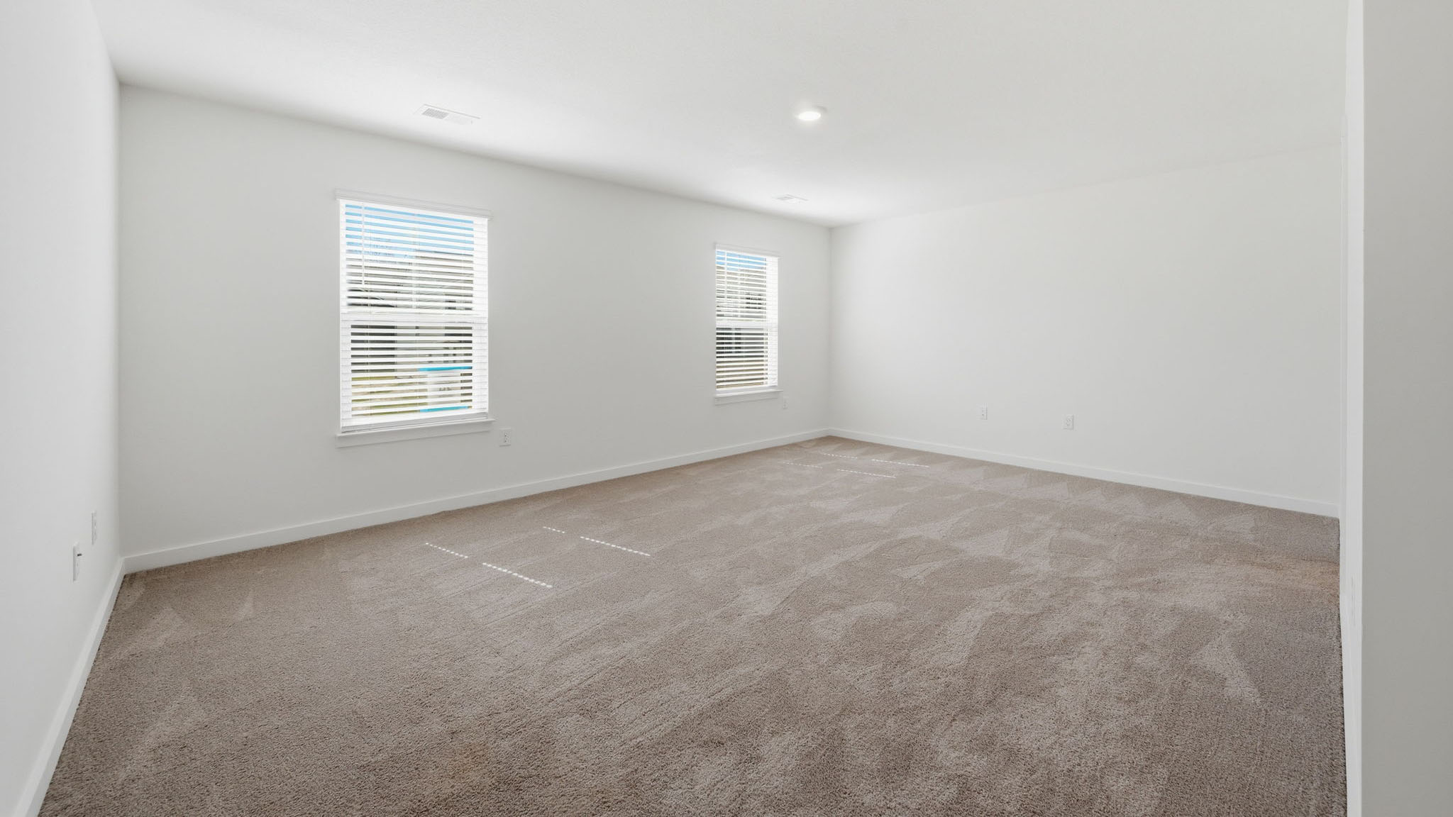 Primary bedroom with private attached bathroom and walk-in closet