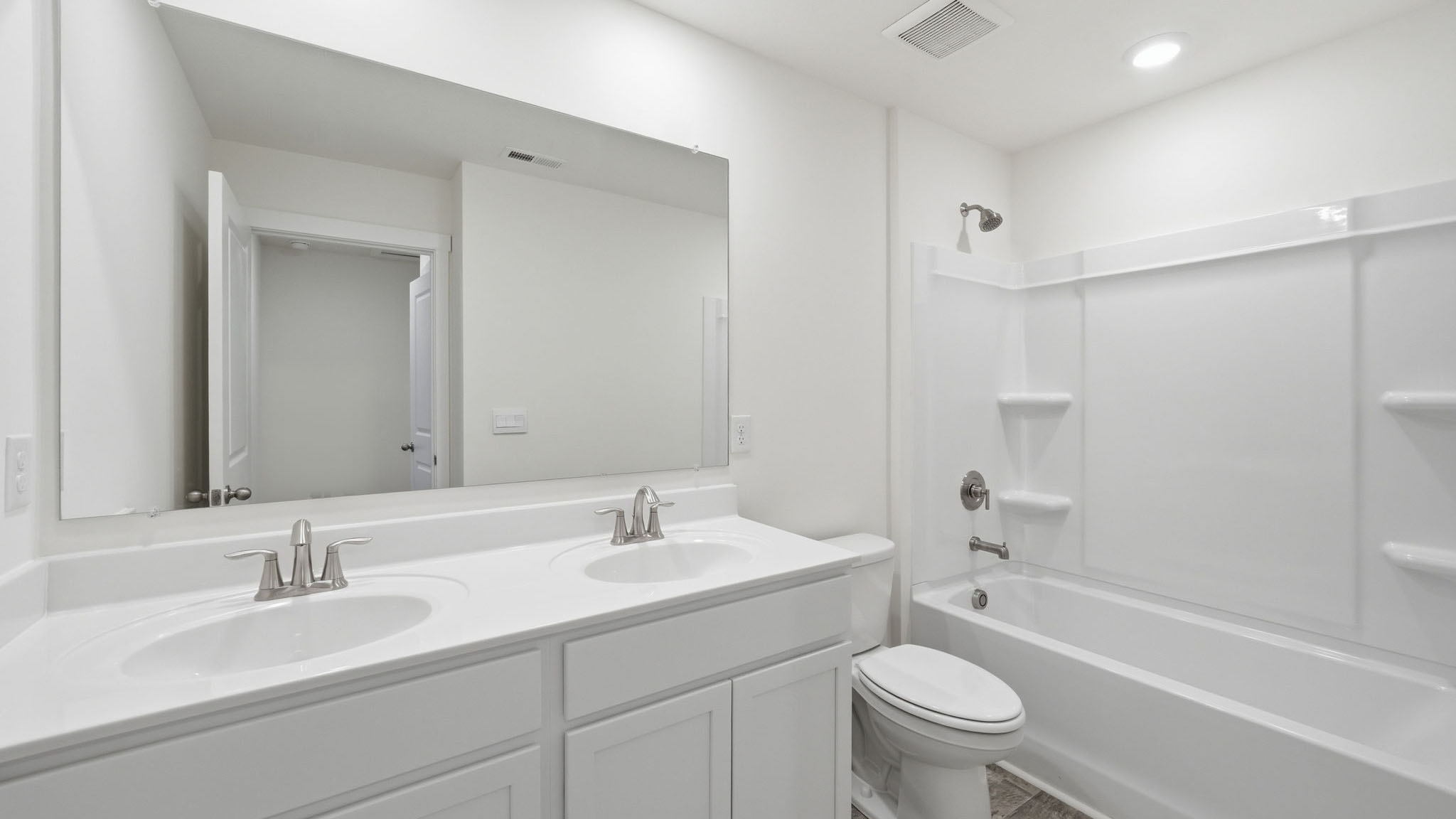 Primary bathroom with double vanity and walk-in shower
