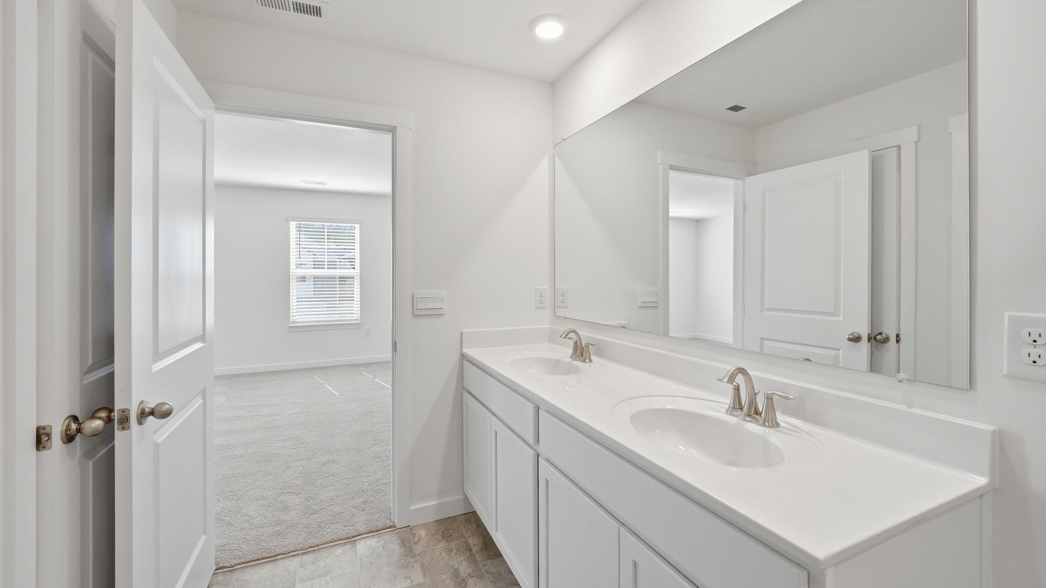 Primary bathroom with double vanity and walk-in shower