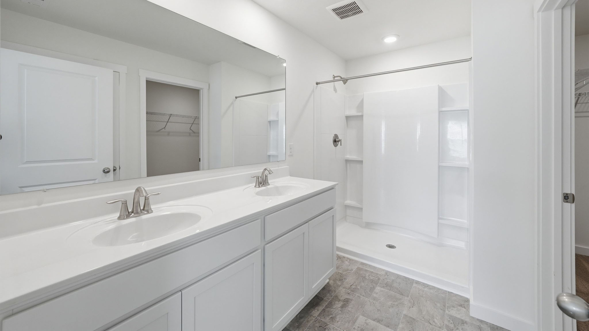 Primary bathroom with double vanity and walk-in shower
