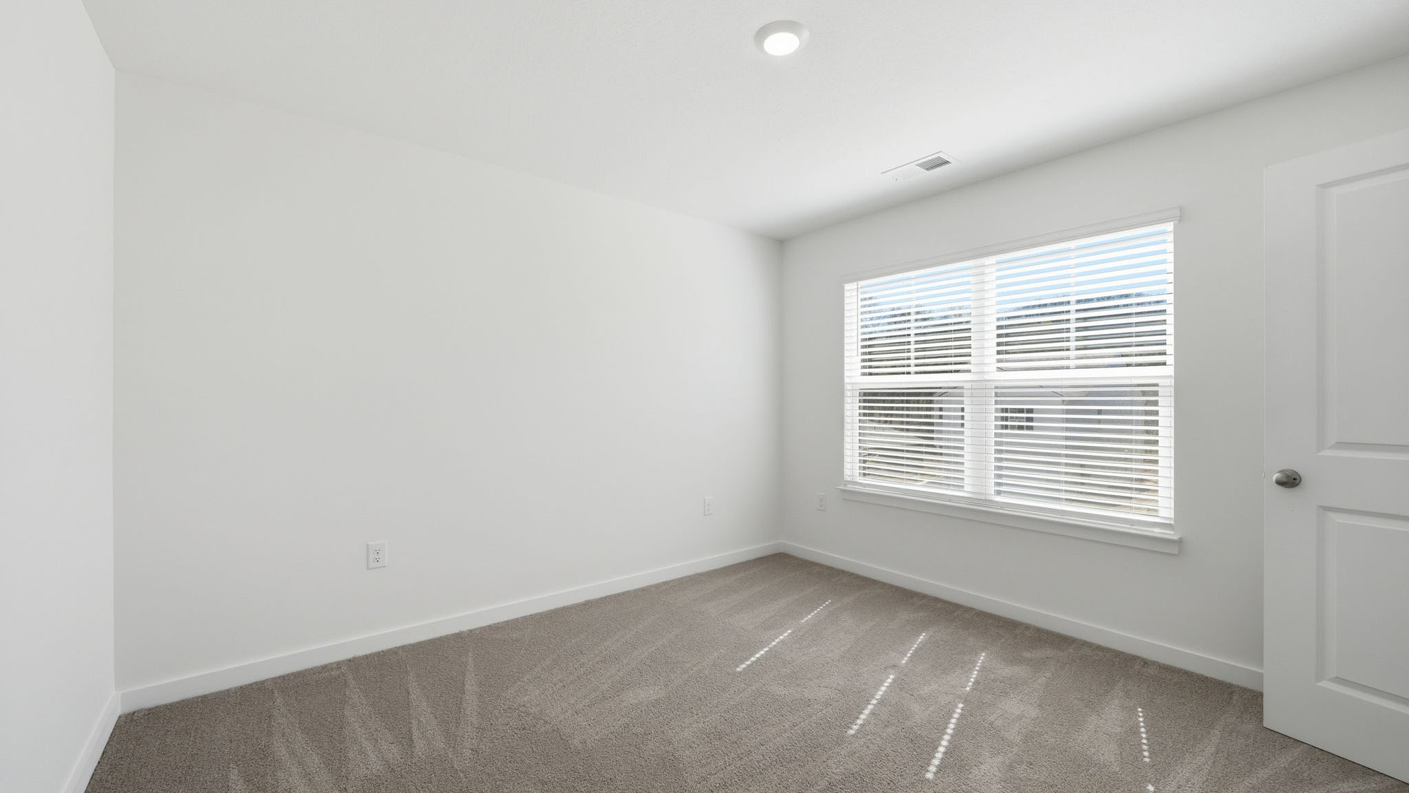 Bedroom with ample natural light and carpet floors