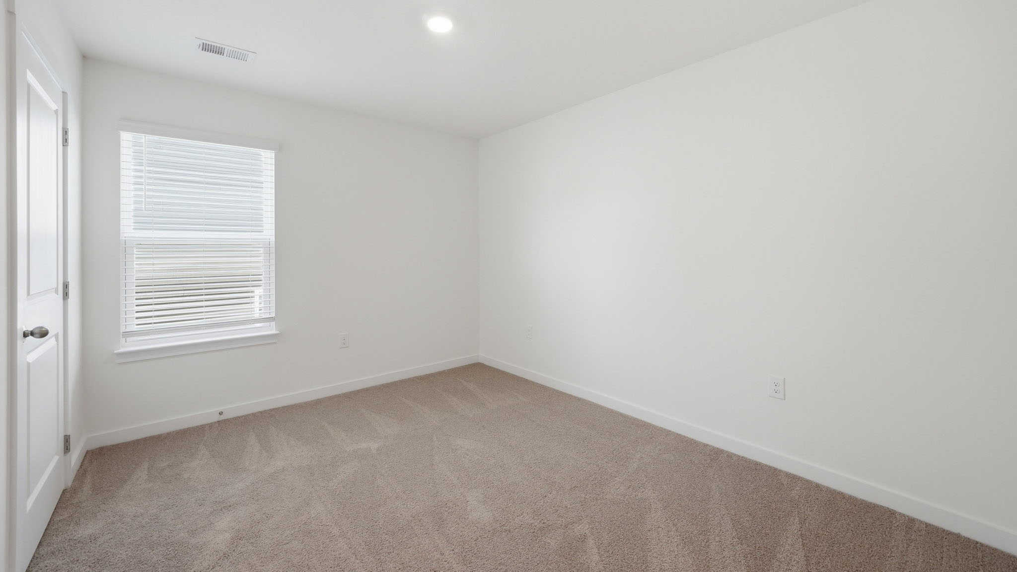 Bedroom with ample natural light and carpet floors