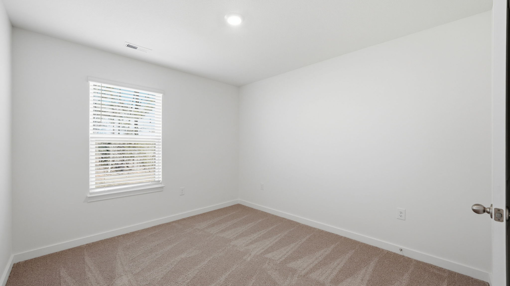 Bedroom with ample natural light and carpet floors