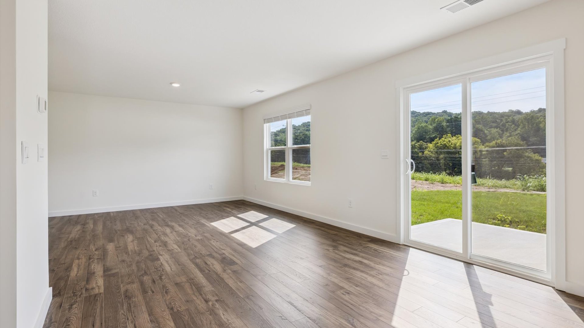 Spacious living and great  room space with light allowing windows