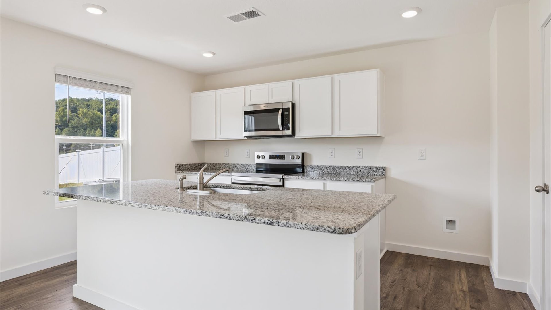 Spacious open concept kitchen with island and counter prep space