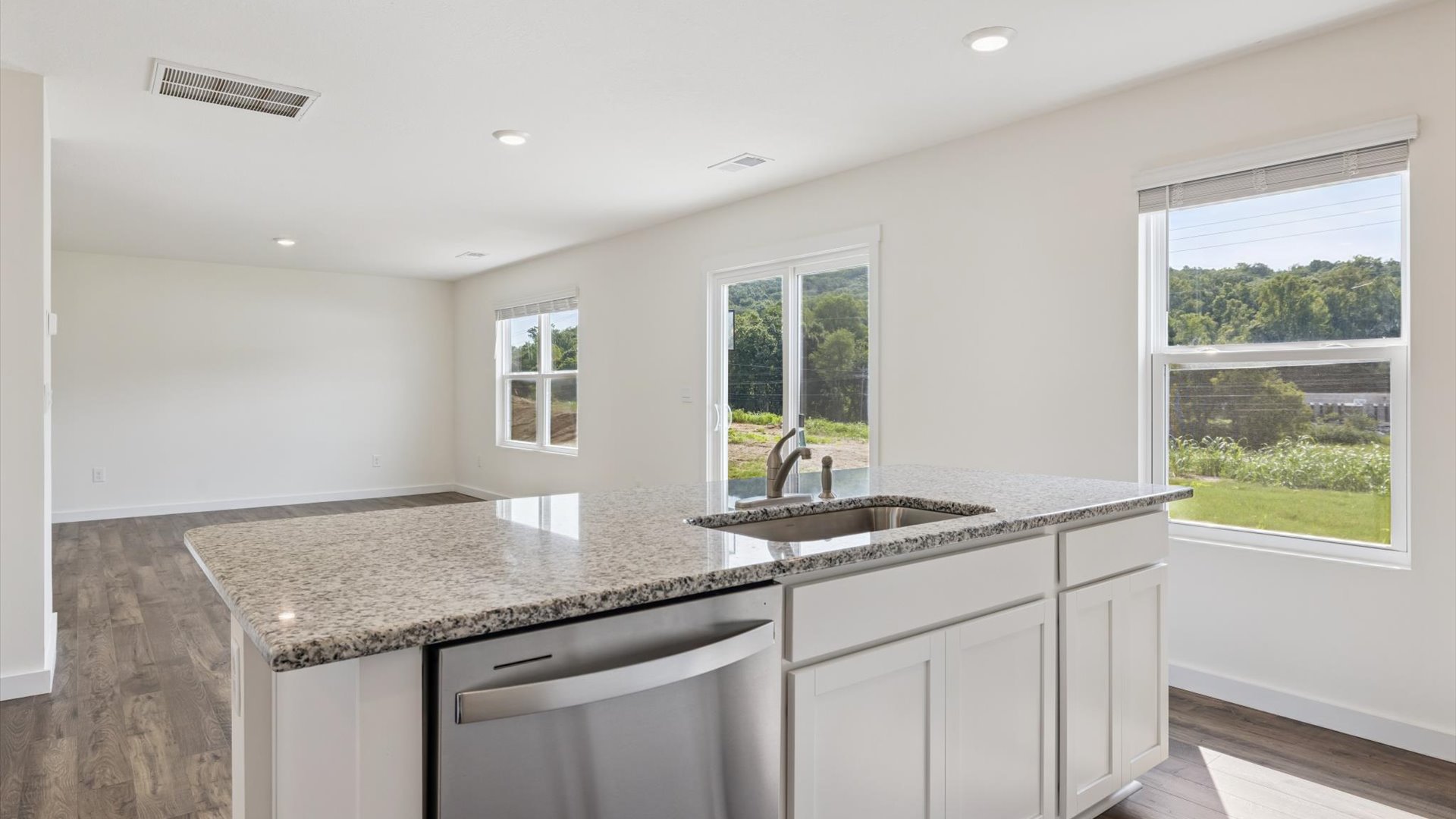 Kitchen with stainless steel appliances, shaker style cabinets, and elevated finishes