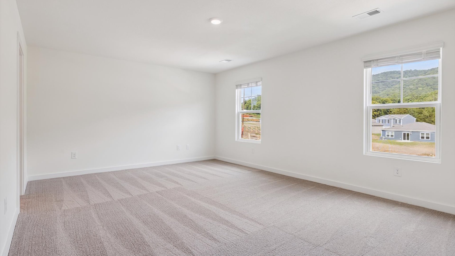 Upstairs guest bedroom 3 with plush carpeted floors and ample natural light