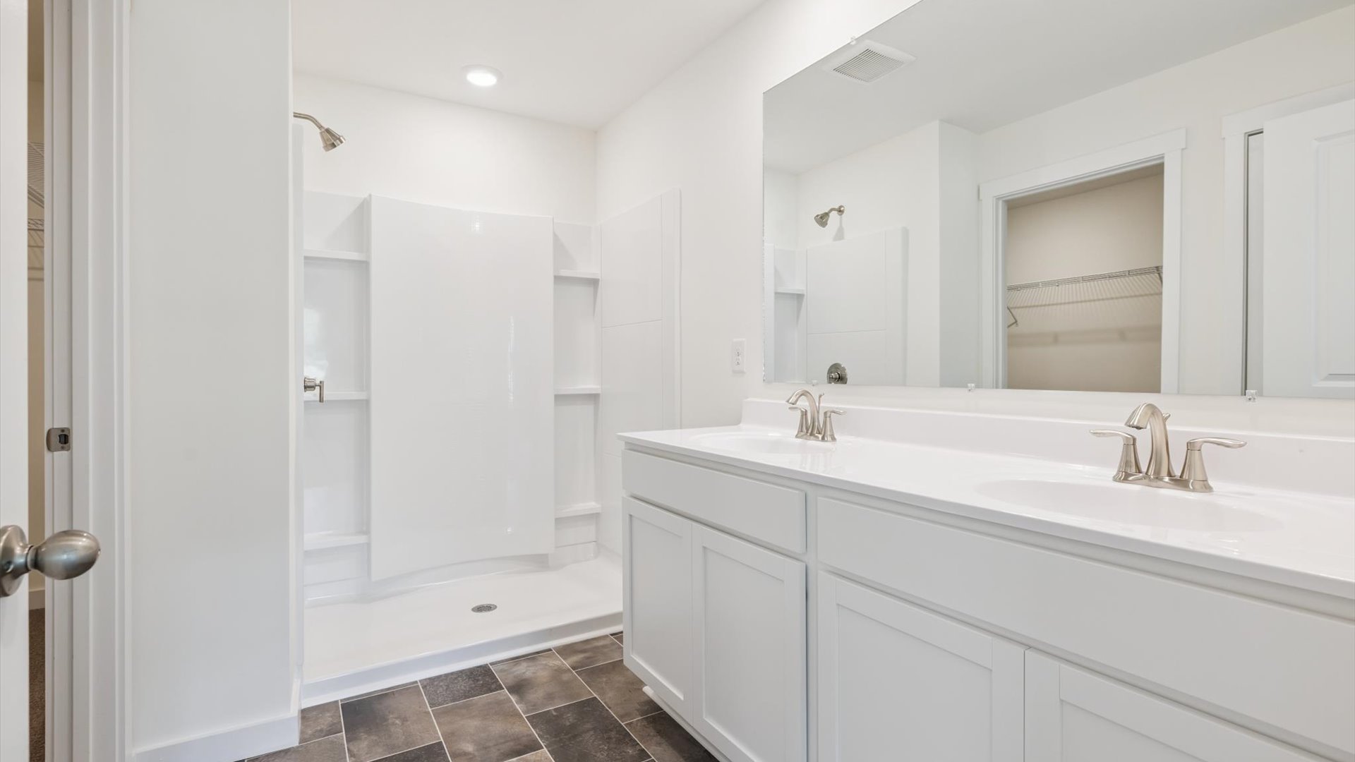 Primary bathroom with luxurious shower and built in storage