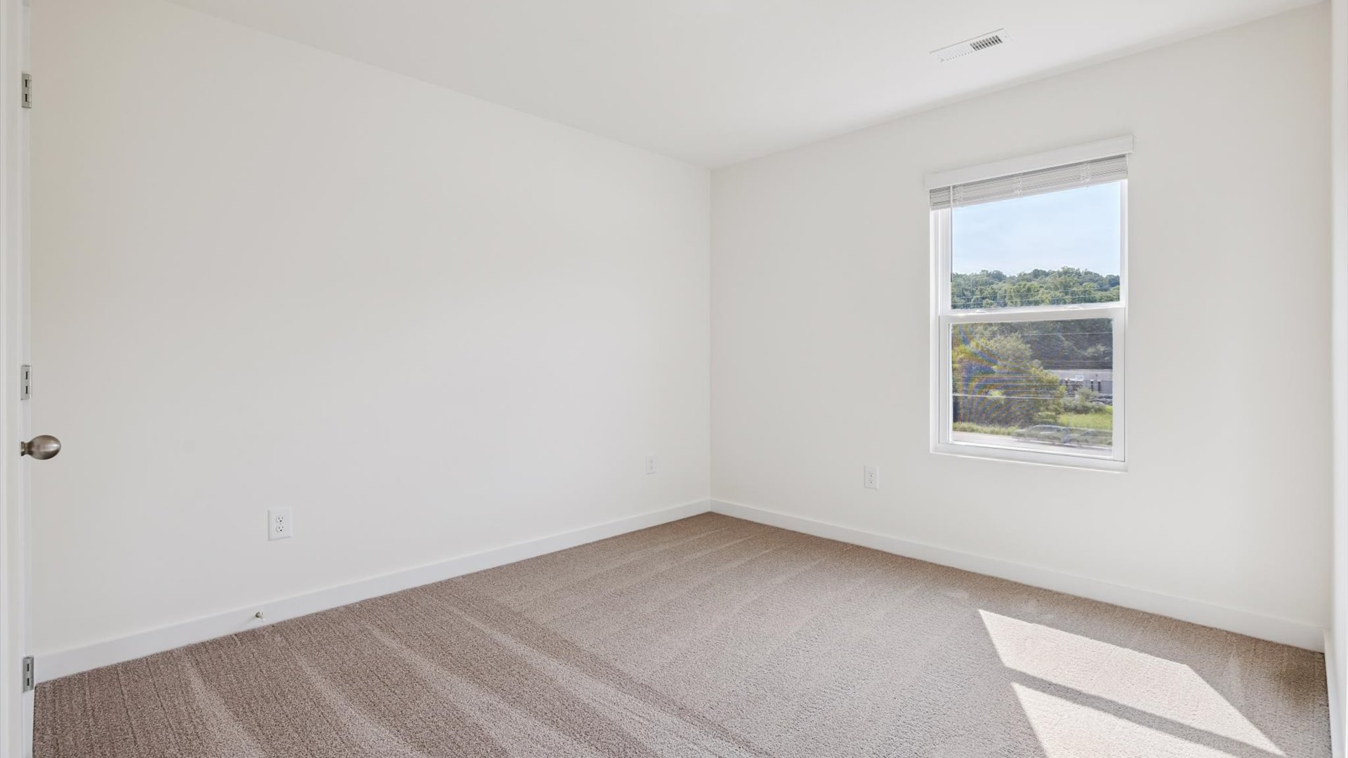 Upstairs guest bedroom 2 with plush carpet floors