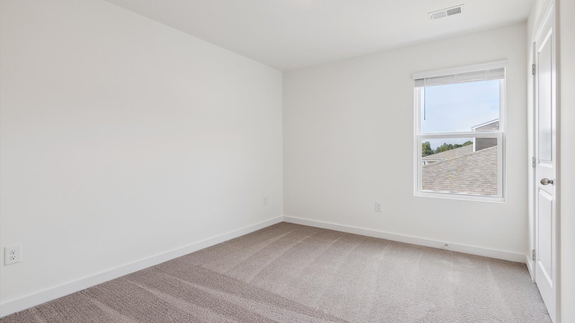Upstairs guest bedroom 2 with plush carpet floors