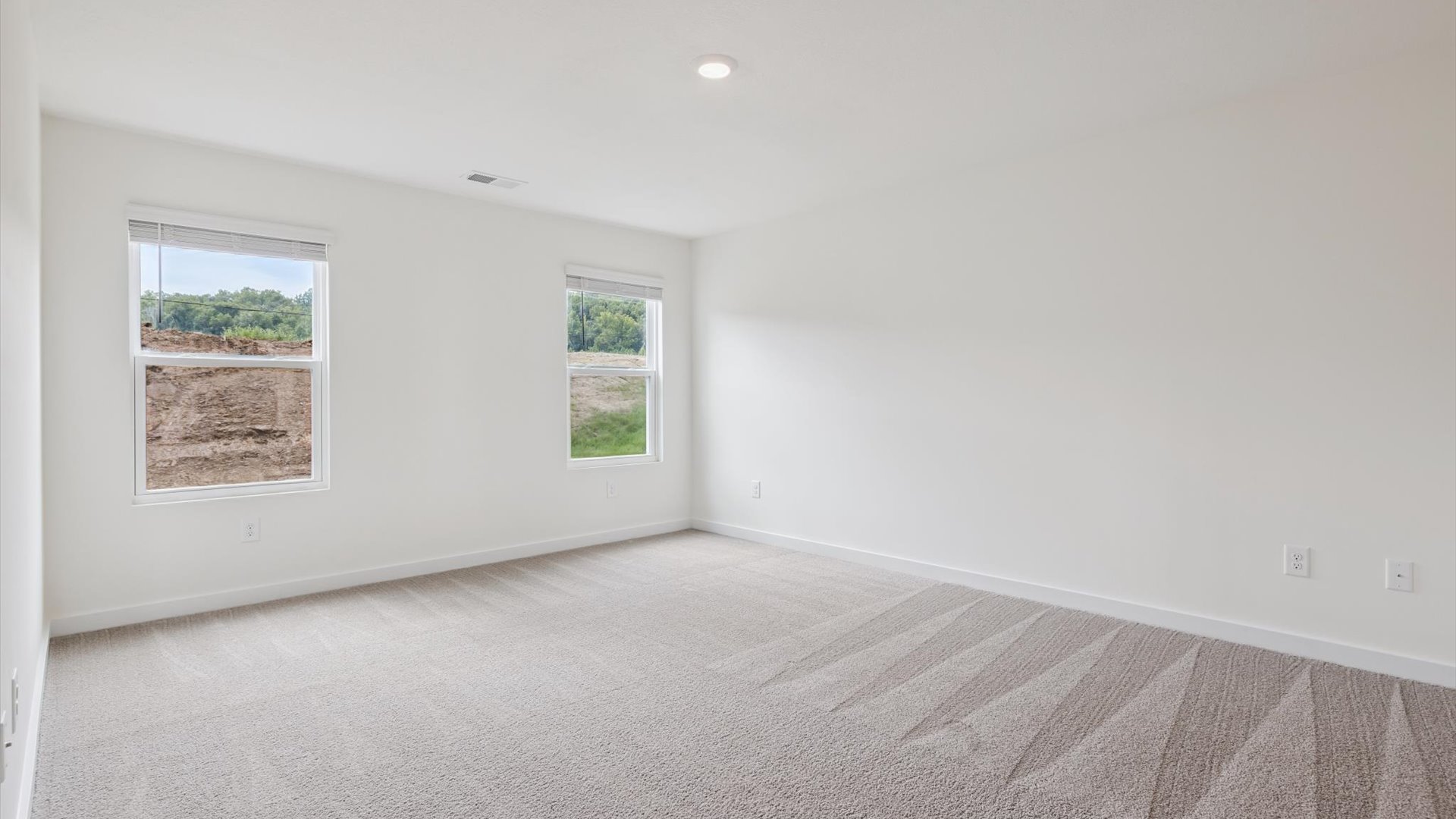 Primary bedroom designed for privacy and space with a convenient flow into spa-inspired ensuite bathroom and walk-in closet