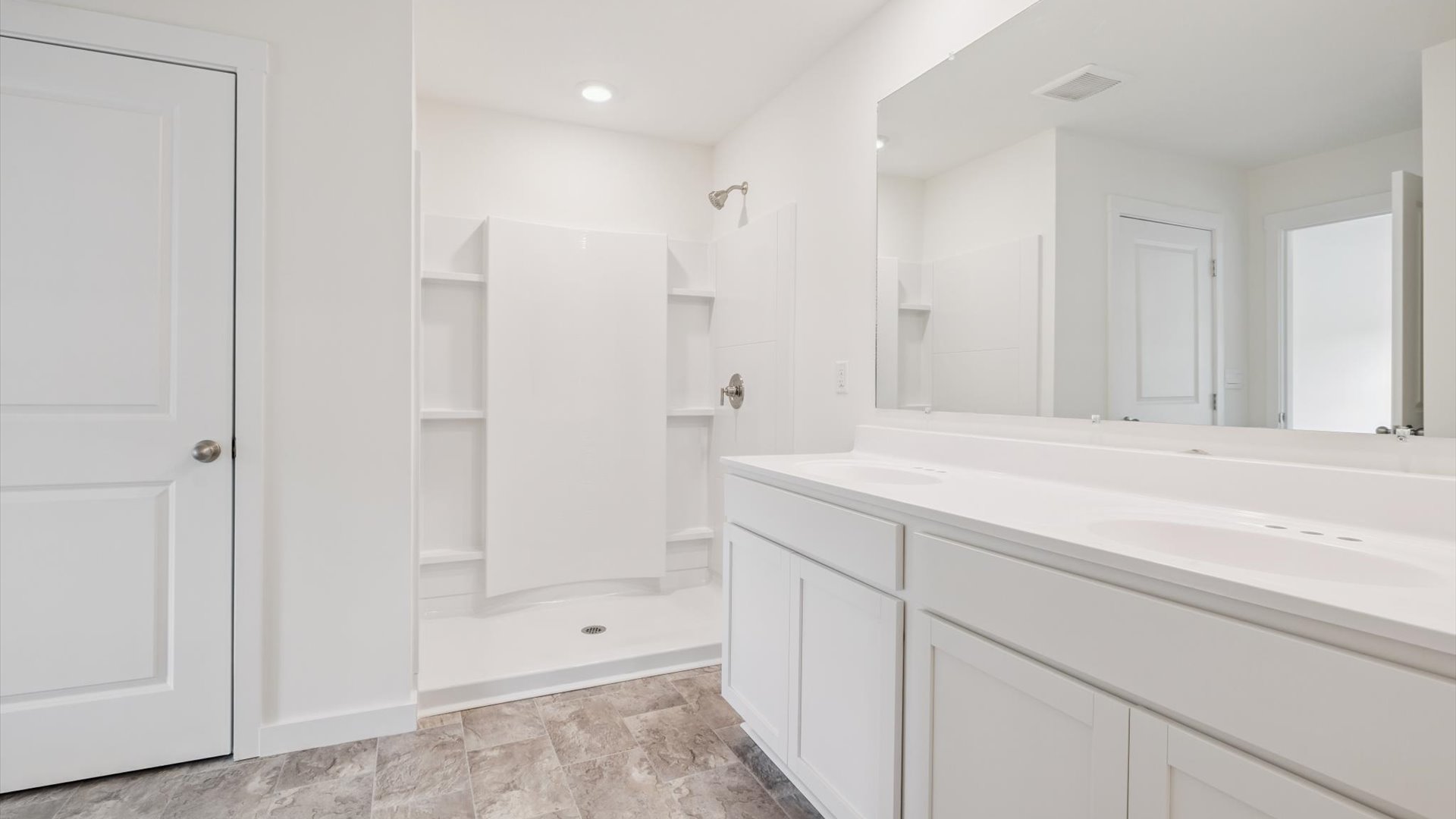 Family bathroom with stylish vanity, mirror, polished fixtures, cabinets, tub-shower combo in Emory Creek