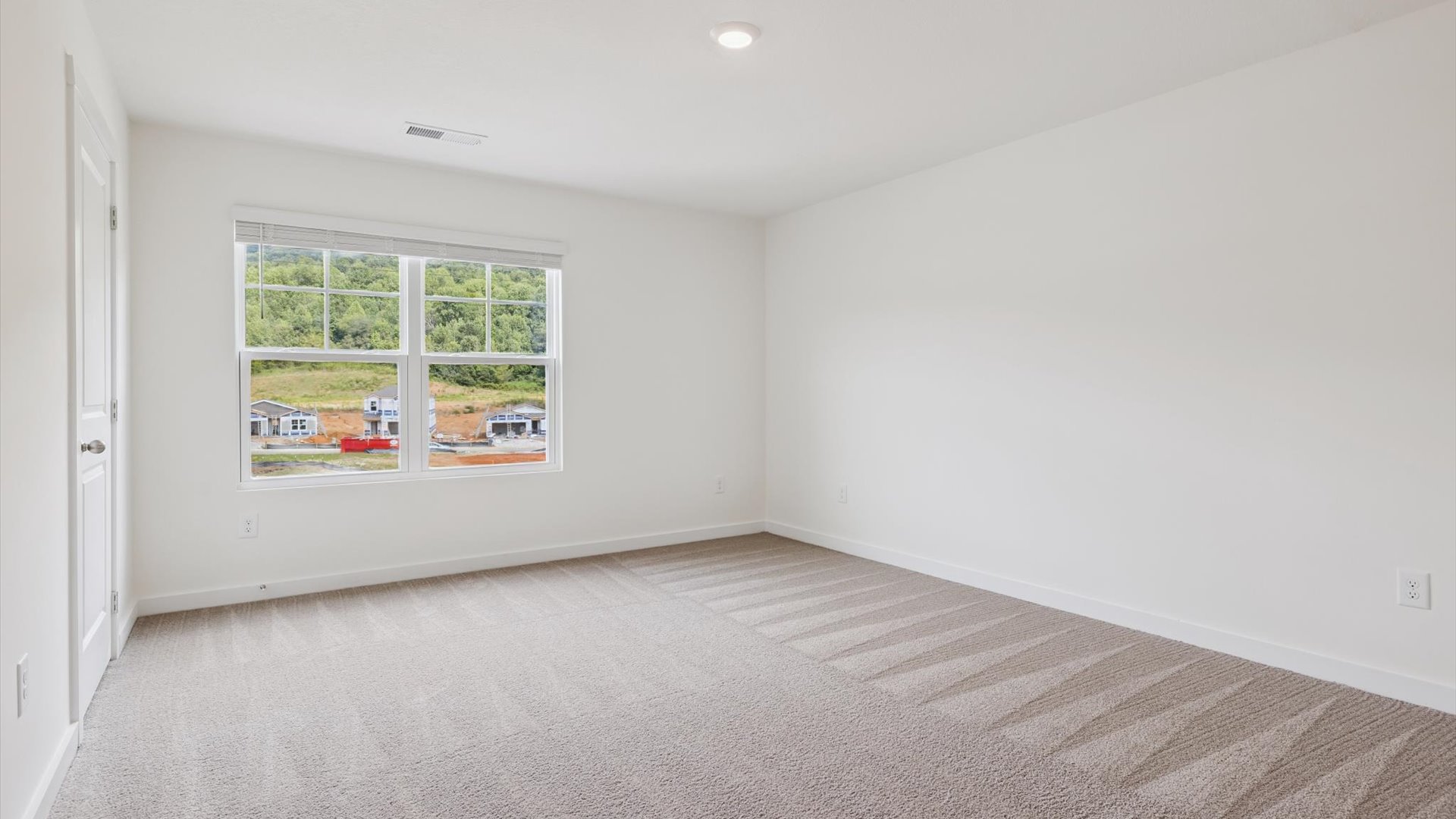 Owner’s suite offers natural window light, a spa-inspired ensuite bathroom, and spacious walk-in closet for everyday comfort