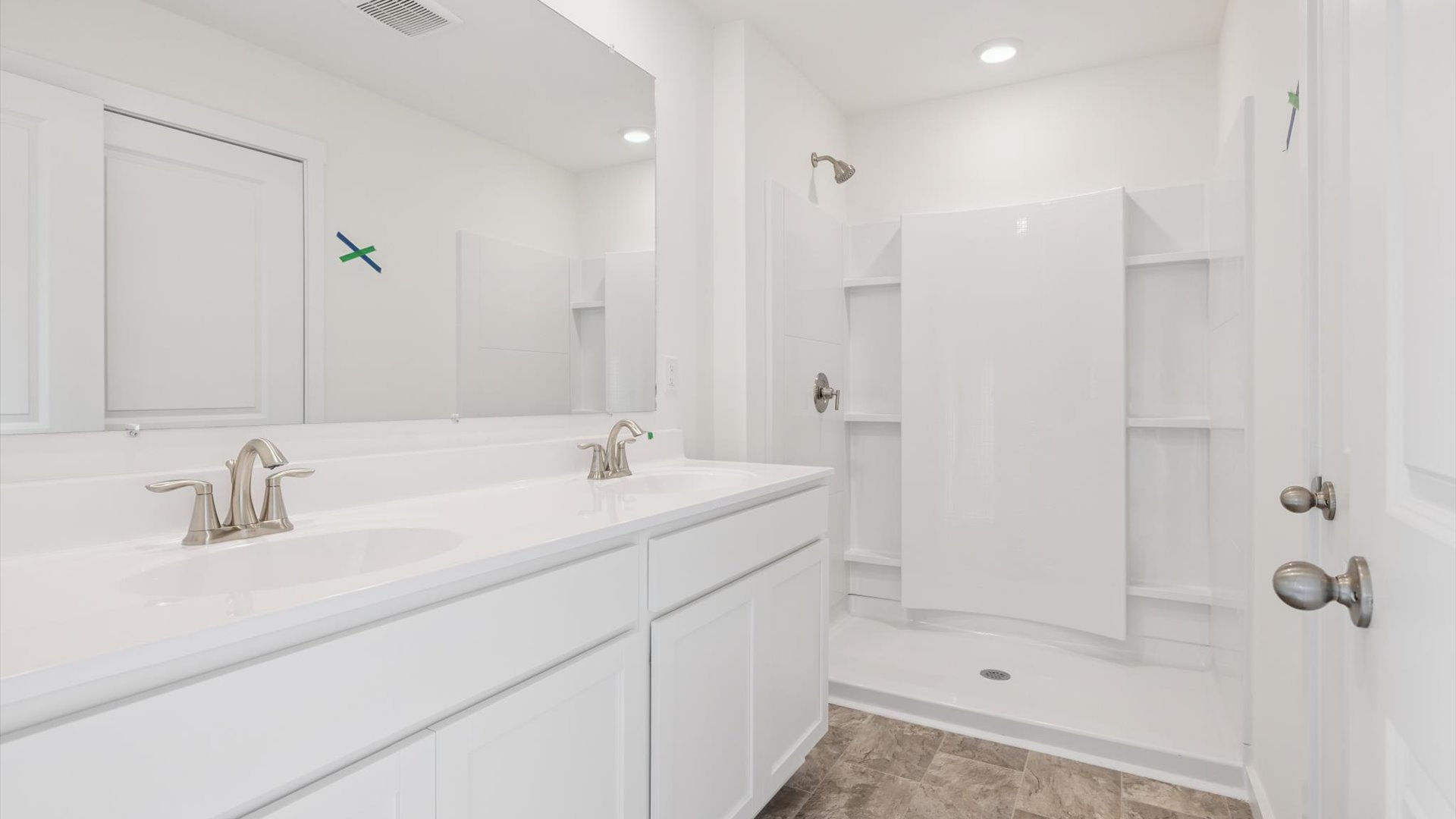 Owner’s ensuite in a new build home offers function and style with a walk-in closet, spa-like ensuite