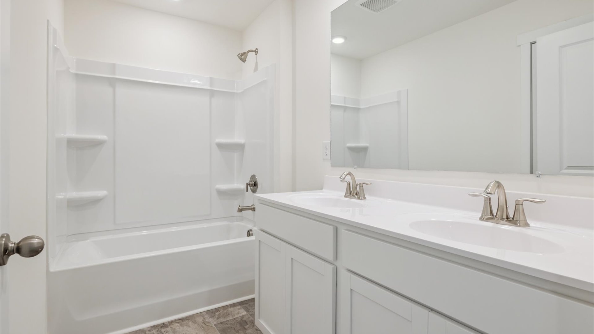 Sleek family-guest bath with single sink, mirror, cabinets, and shower-tub combination at Emory Creek