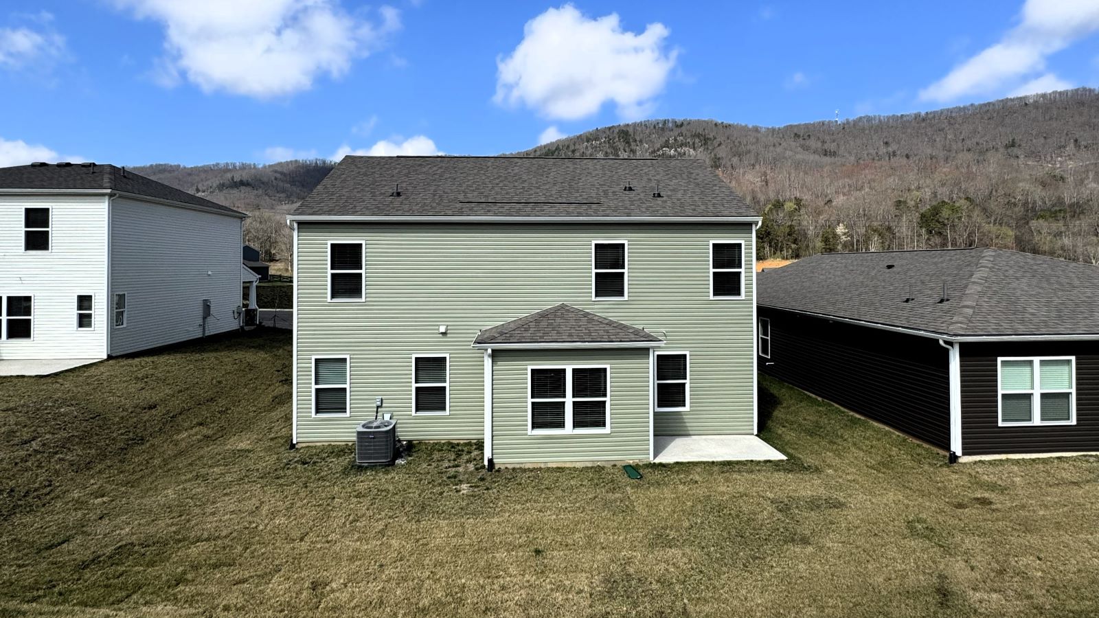 rear exterior of two story home and backyard
