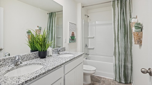 Bathroom with a double vanity and shower with garden tub