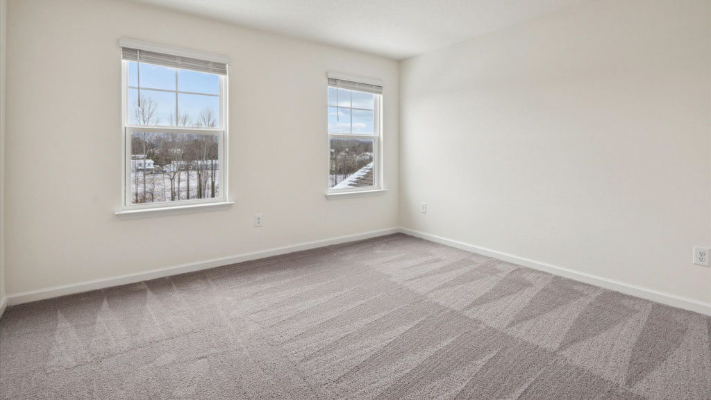 Bedroom with ample natural light and carpet floors