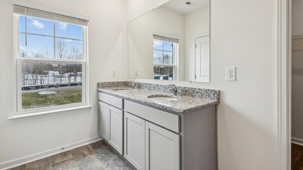 Primary bathroom with double vanity and walk-in shower