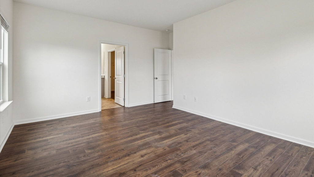 Primary bedroom with private attached bathroom and walk-in closet