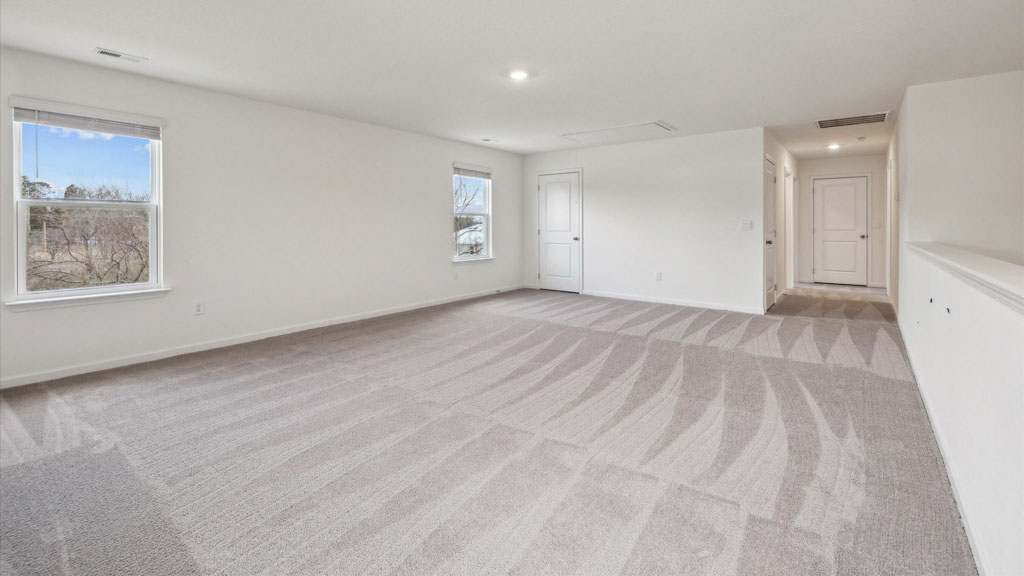 Bedroom with ample natural light and carpet floors