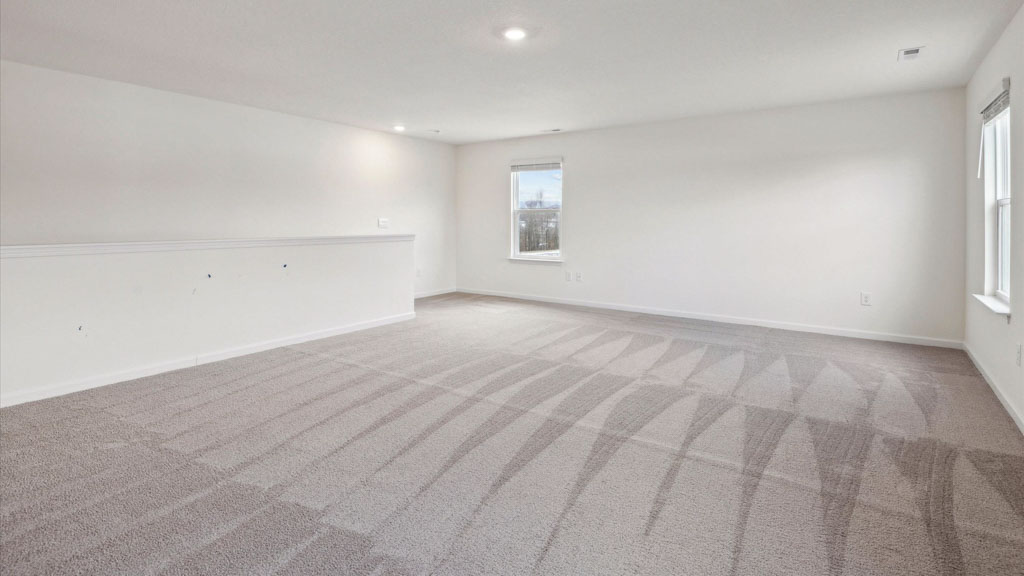 Bedroom with ample natural light and carpet floors
