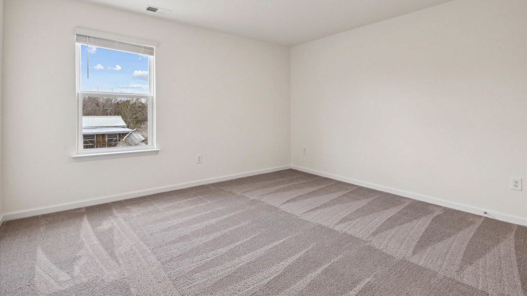 Bedroom with ample natural light and carpet floors