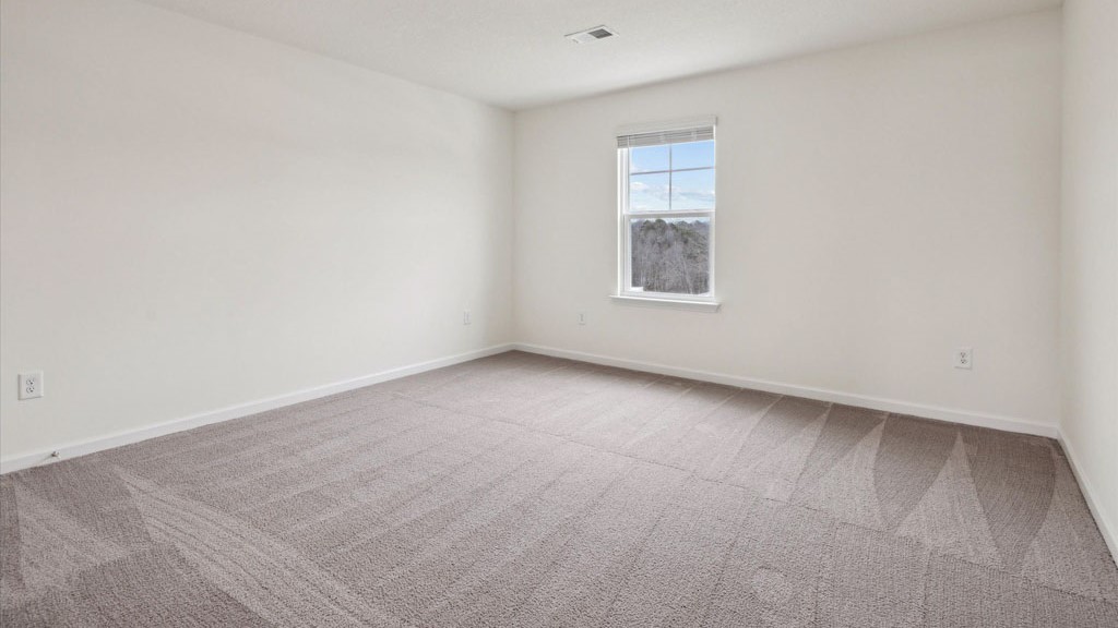 Bedroom with ample natural light and carpet floors