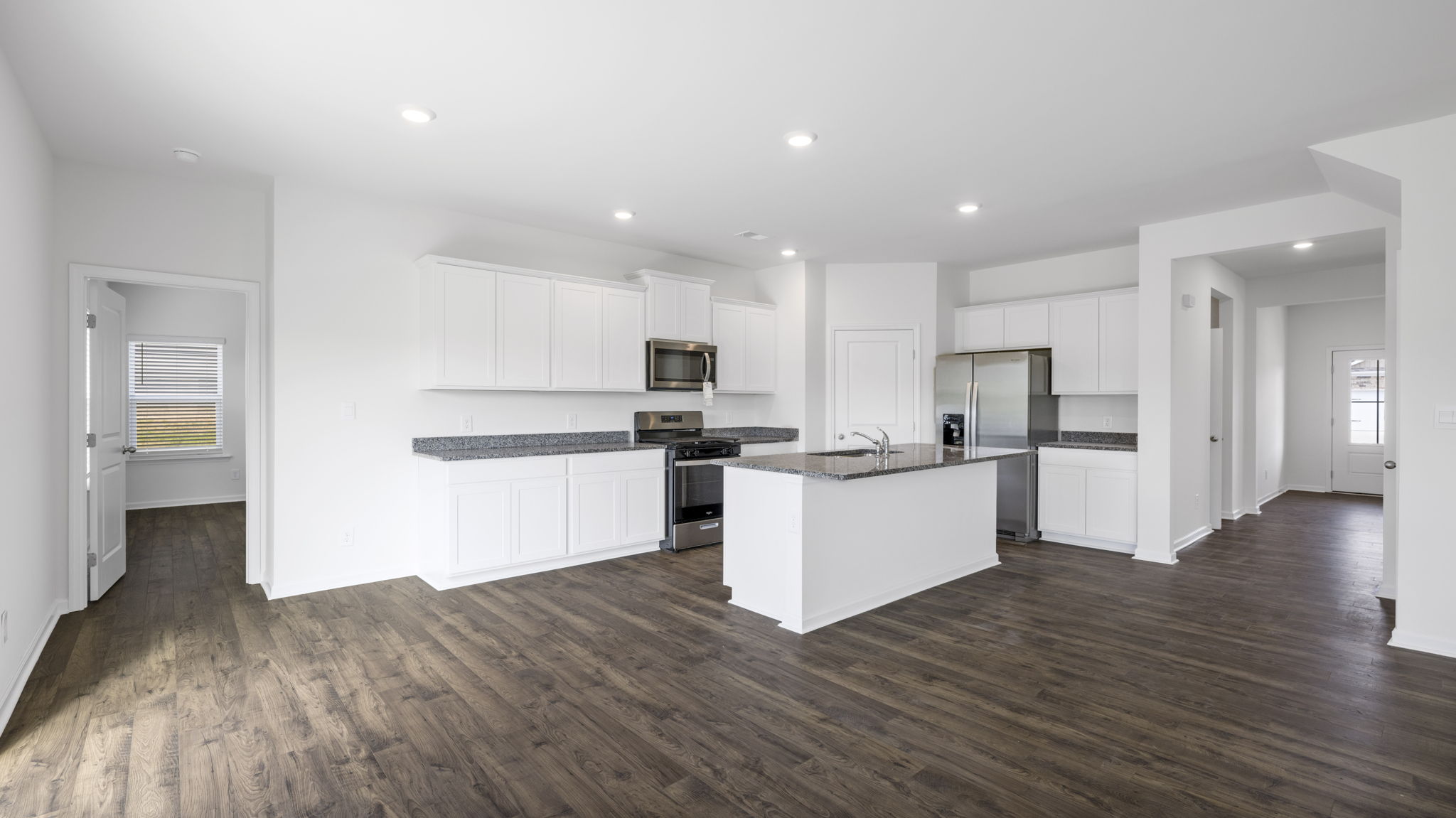 Open concept living, dining, and kitchen space