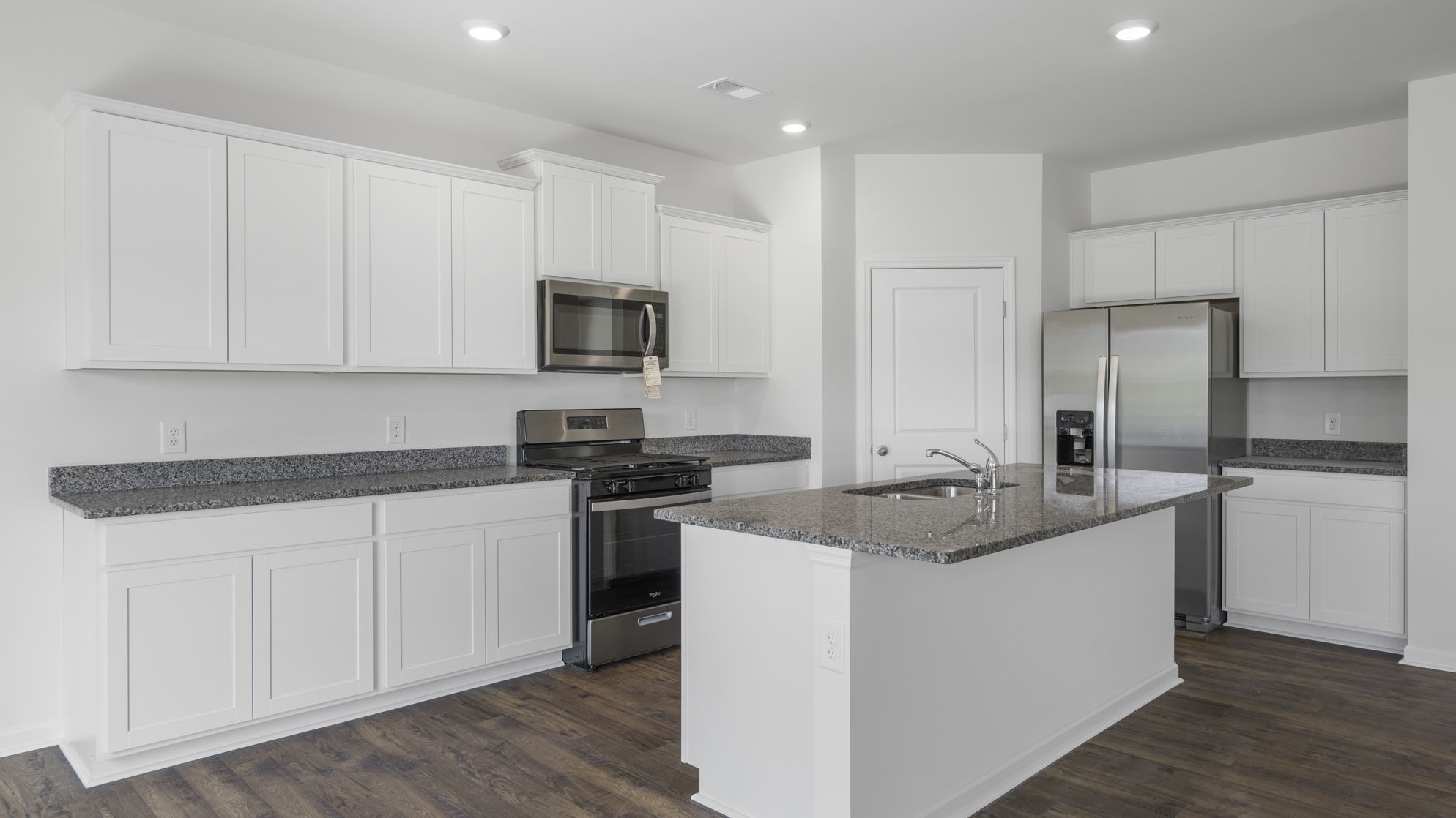 Open concept living, dining, and kitchen space