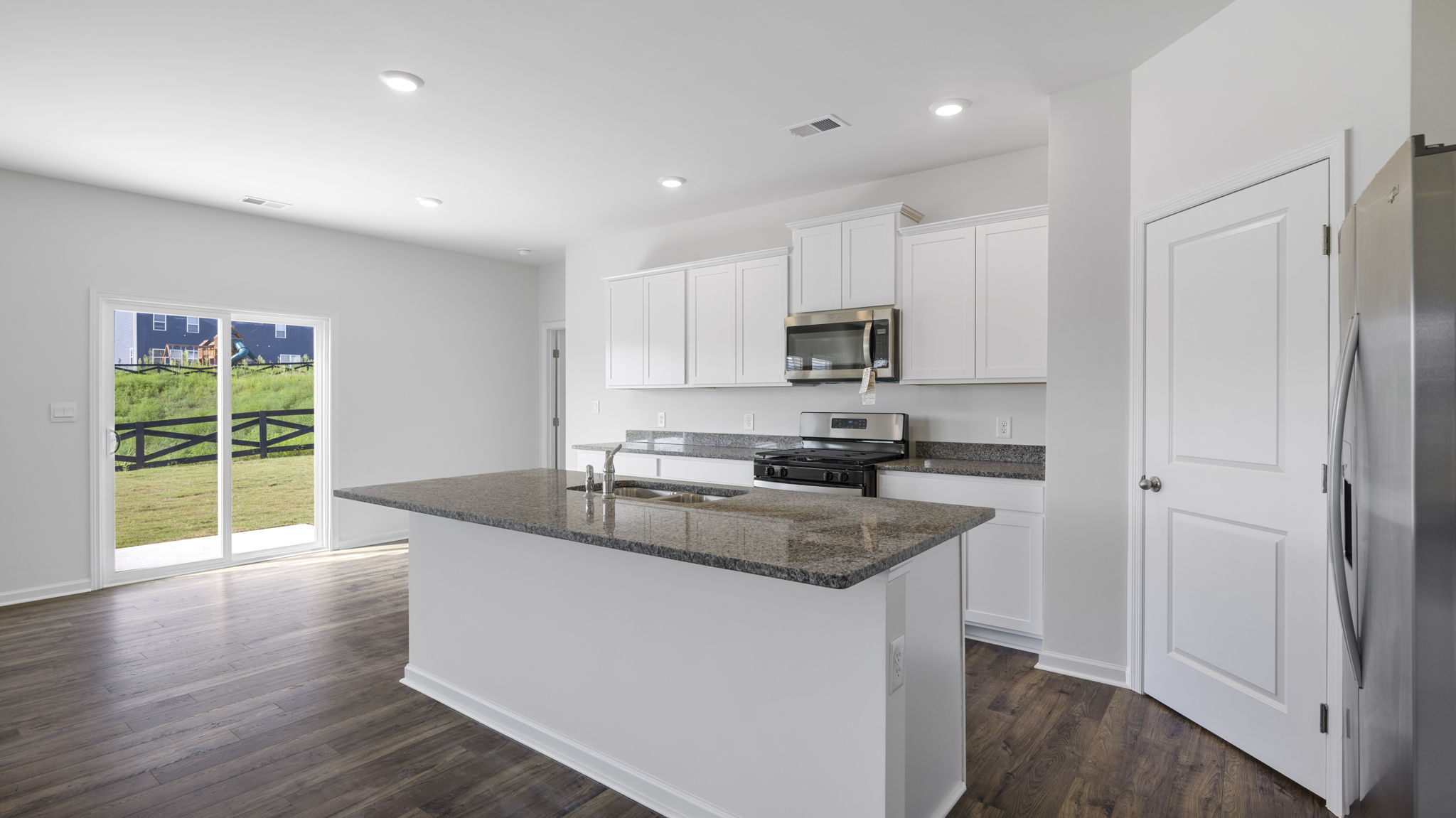 Open concept living, dining, and kitchen space